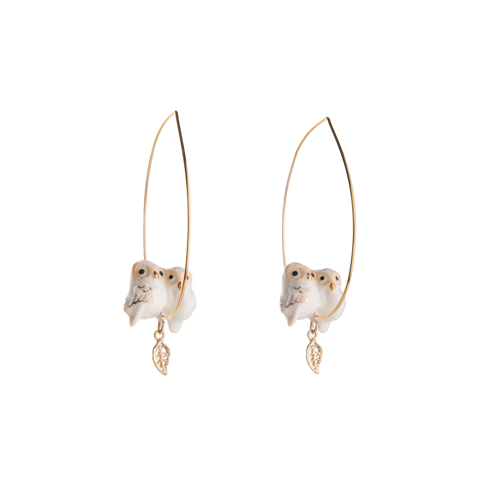 We love these cuddly owl besties on a delicate hoop! These gold-plated hoop earrings feature twin owls snuggled over a dangling gold leaf. On a delicate hoop, these earrings bring natural glam to any look. Lead and Nickel-free Material: Porcelain, Gold-plated Stainless Steel Designed in Toulouse, France.