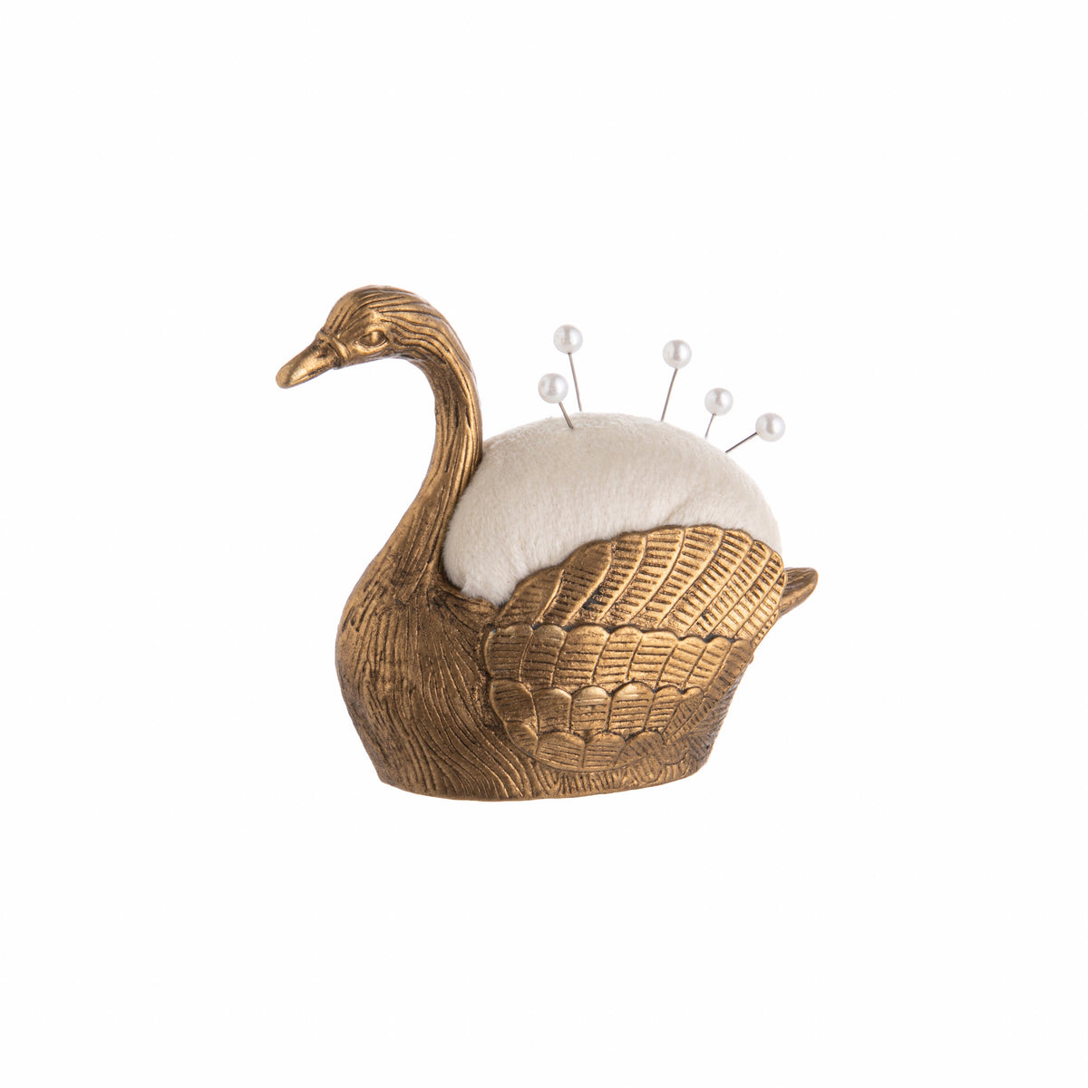 Gold swan-shaped pin cushion with a white cushion on a white background