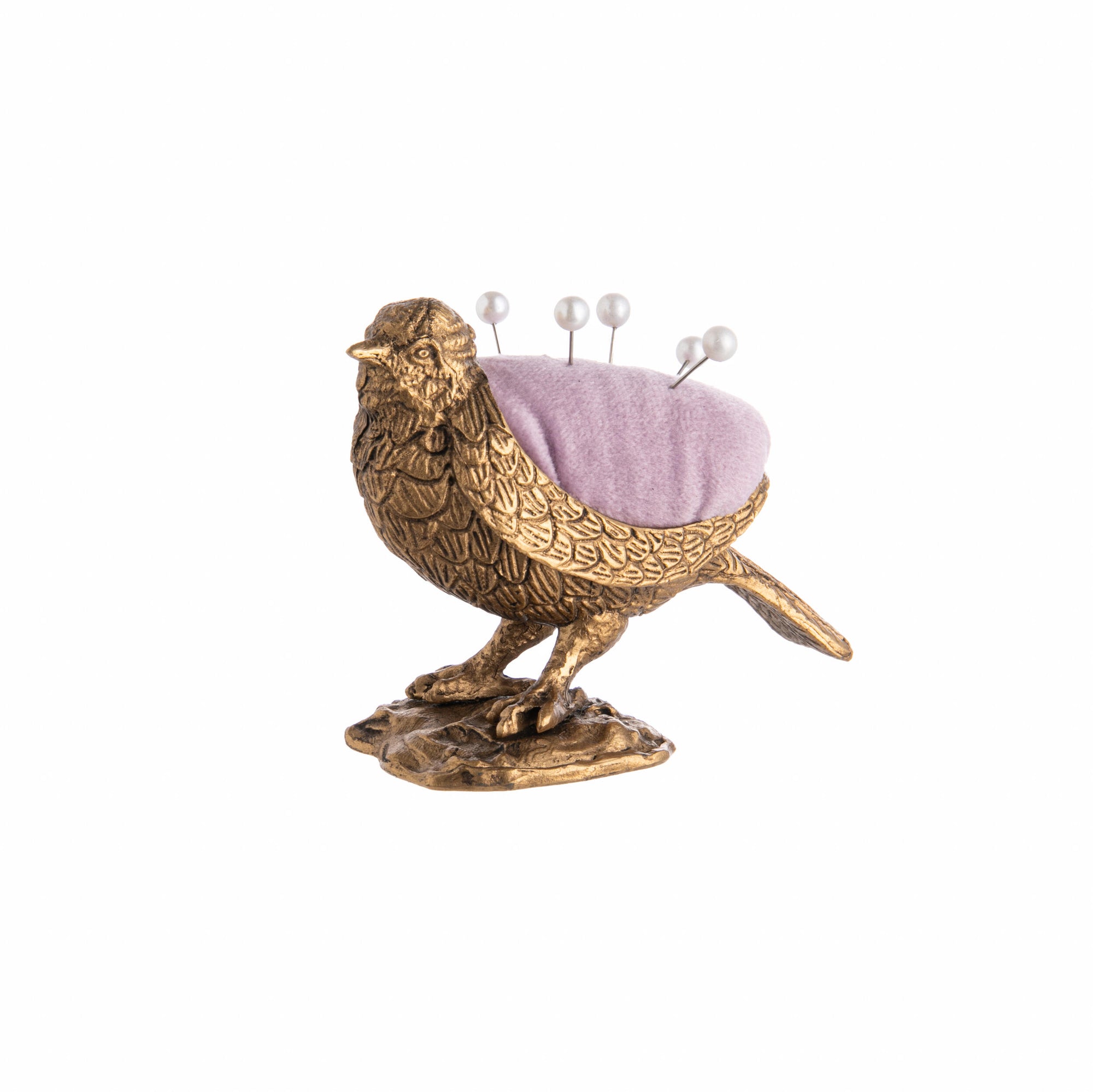 Decorative bird-shaped pin cushion with a pink cushion and pins on a white background
