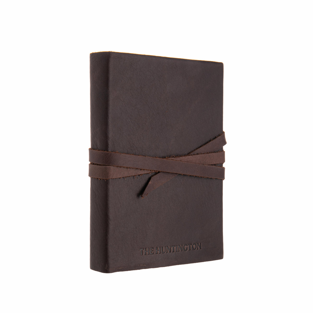 Brown leather-bound book with a strap closure on a white background