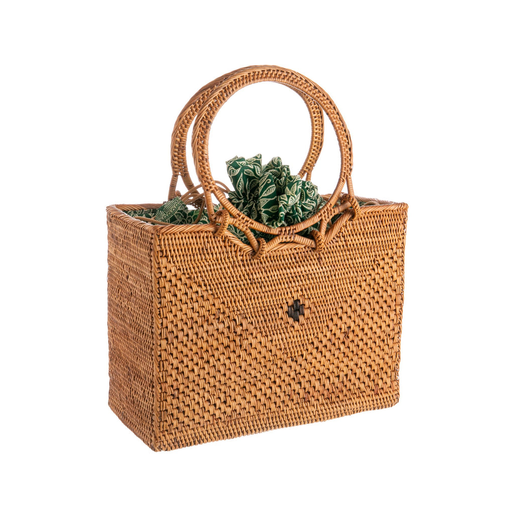 This wonderful rattan purse is skillfully hand woven by Balinese women working from their homes in the Tenganan Village in Bali. The purse also features a pretty and practical green batik print cotton lining, which has a drawstring cord to close the purse to keep the contents safely hidden away. 10.5" x 7.5" x 4.5".