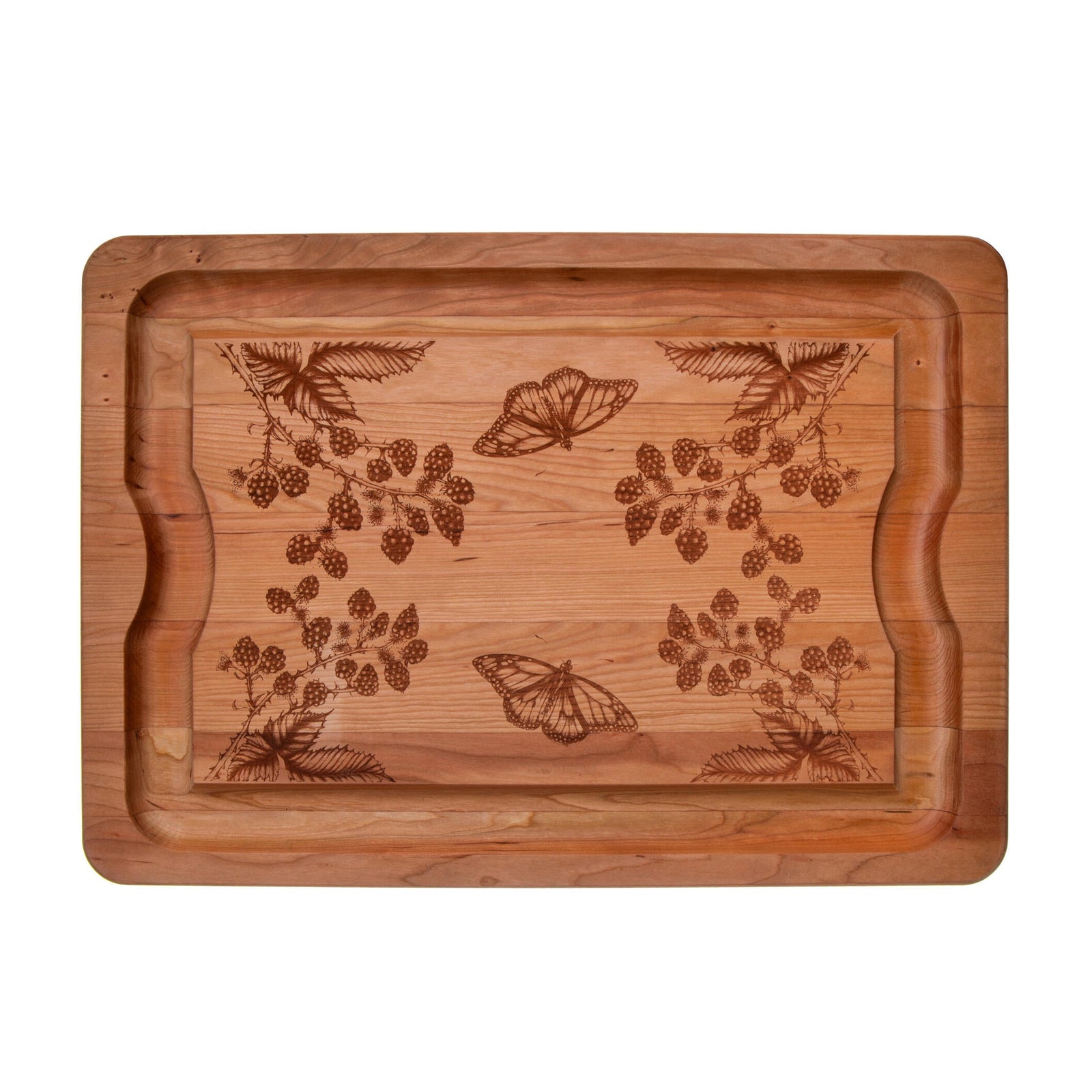 Wooden cutting board with engraved floral and butterfly designs on a white background