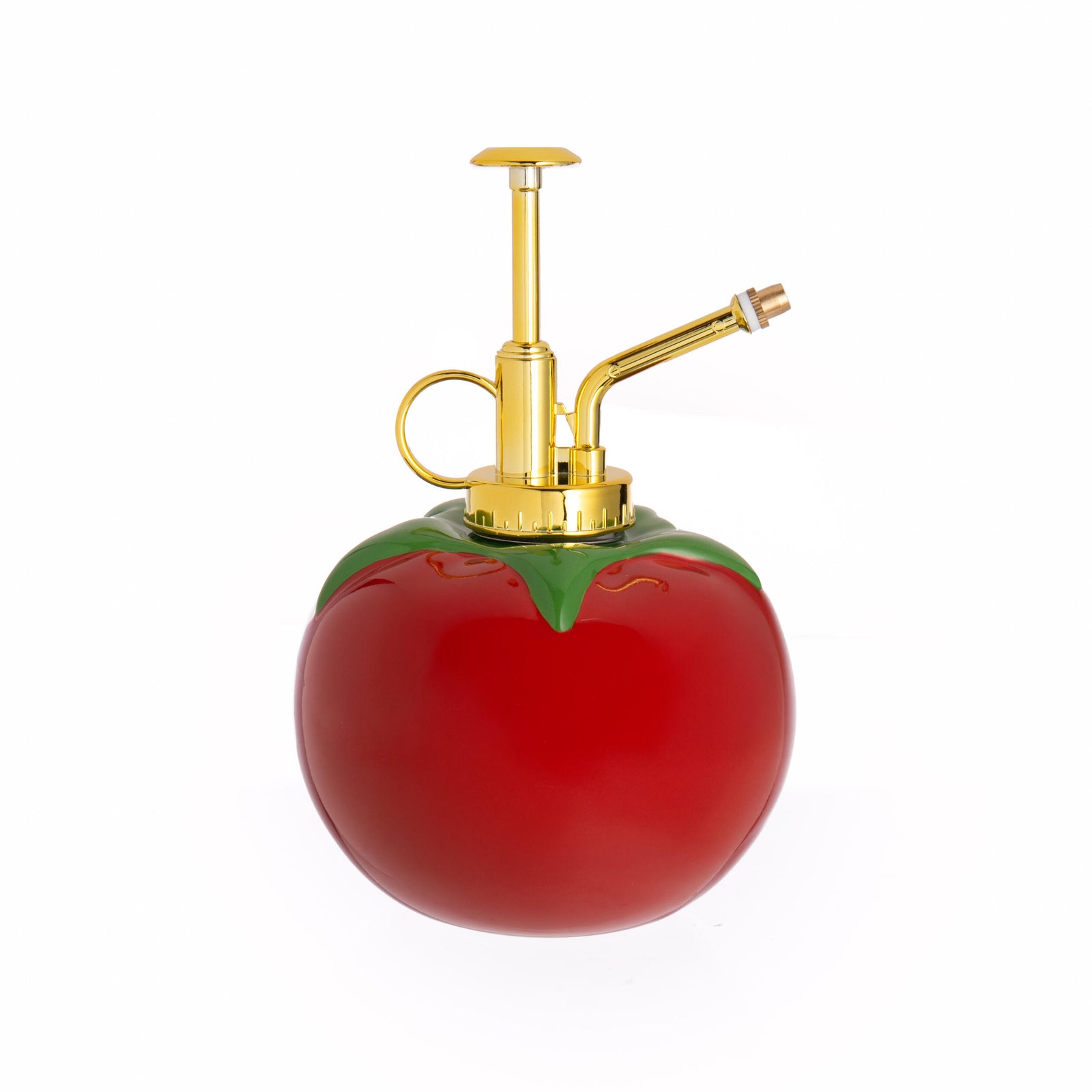 Tomato-shaped spray bottle with gold nozzle on a white background
