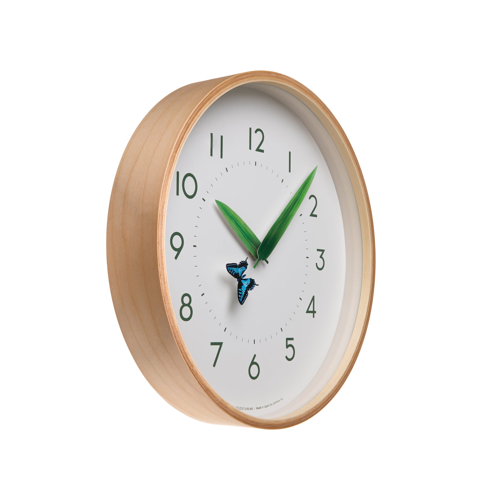 Once an hour, when the minute hand and the hour hand line up perfectly, the butterfly will land on the leaves to rest. The hands on the clock are shaped and colored like leaves. At the end of one of the leaves sits a blue butterfly. The clock is encircled by a handmade natural plywood frame. Diameter: 10". Depth 13/4" 
