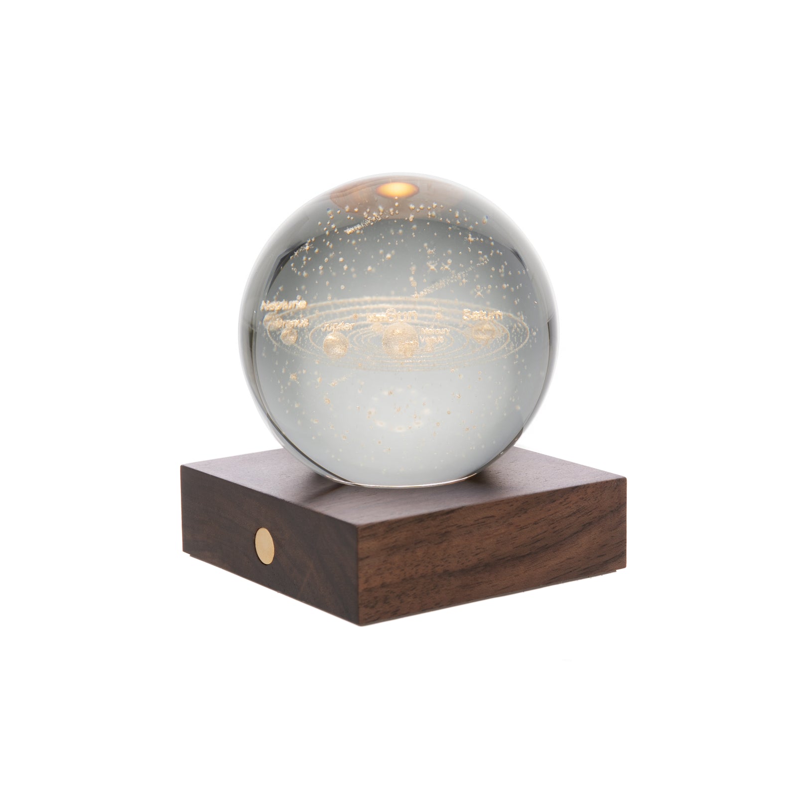 A polished amber crystal globe on a walnut wood base, with a solar system motif.
