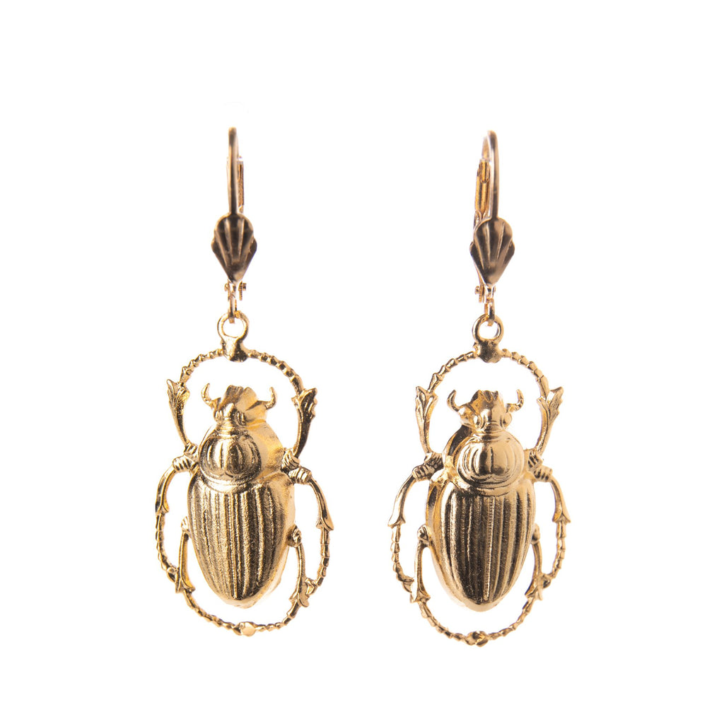 Channel your inner Cleopatra with these gold-plated Scarab beetle earrings. These lightweight and highly detailed earrings add a subtle statement to any daytime or evening outfit. Made by hand by jewelry designer Lotta Djossou in Paris, France. Gold plated stainless metal earrings. Nickel free. 2" long x 3/4" wide.