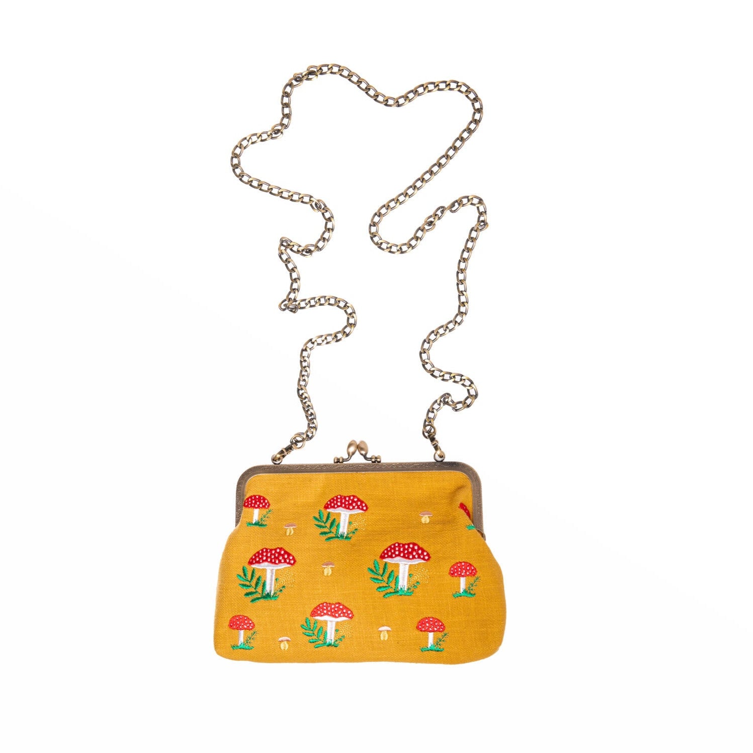 This fabulously fun embroidered mushroom purse is a charming and elegant accessory that combines style with a touch of nature-inspired whimsy. Crafted with meticulous attention to detail, it features embroidered red and taupe mushrooms on both sides. This cleverly designed purse includes two detachable straps, so it can be worn three ways: as a clutch purse, a short-handled purse, or a shoulder bag. 
