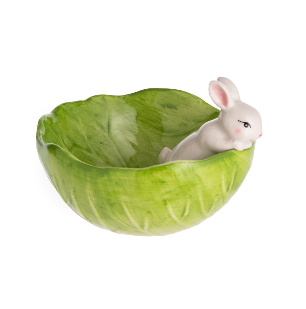 Serve up special spring treats in this adorable bowl. The bowl is shaped like a curled cabbage leaf, with a fresh green color and hand-painted finish. A cute little bunny peers over the edge. It is a perfect centerpiece for a spring or Easter table setting