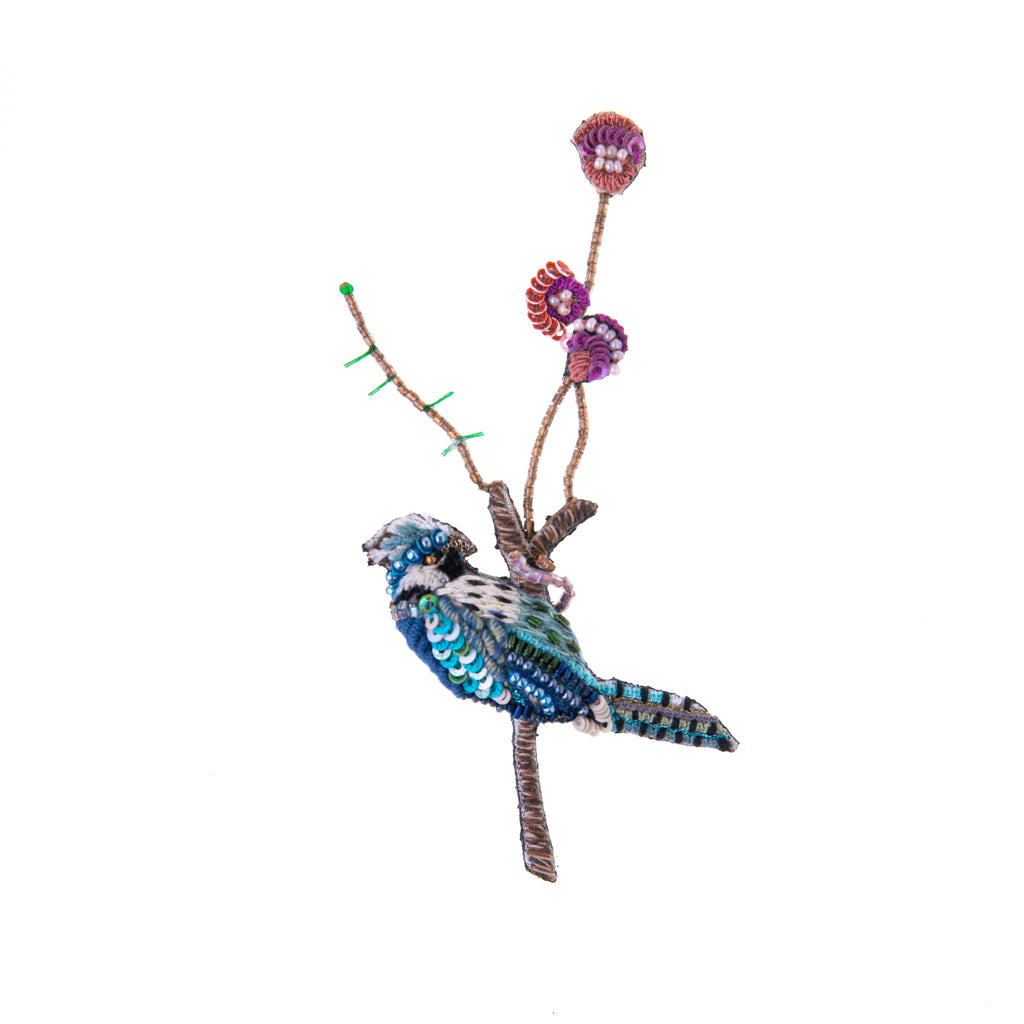 In some cultures, blue jays are a symbol of confidence and also of good things to come. This detailed, hand-made jay bird pin features intricate beading and embroidery on a base of cotton and felt. Add this pin to your outfit for a dose of extra luck and confidence. Materials: Cotton, felt, metal, beads. 3.5" x 2".      316 of 320 characters used