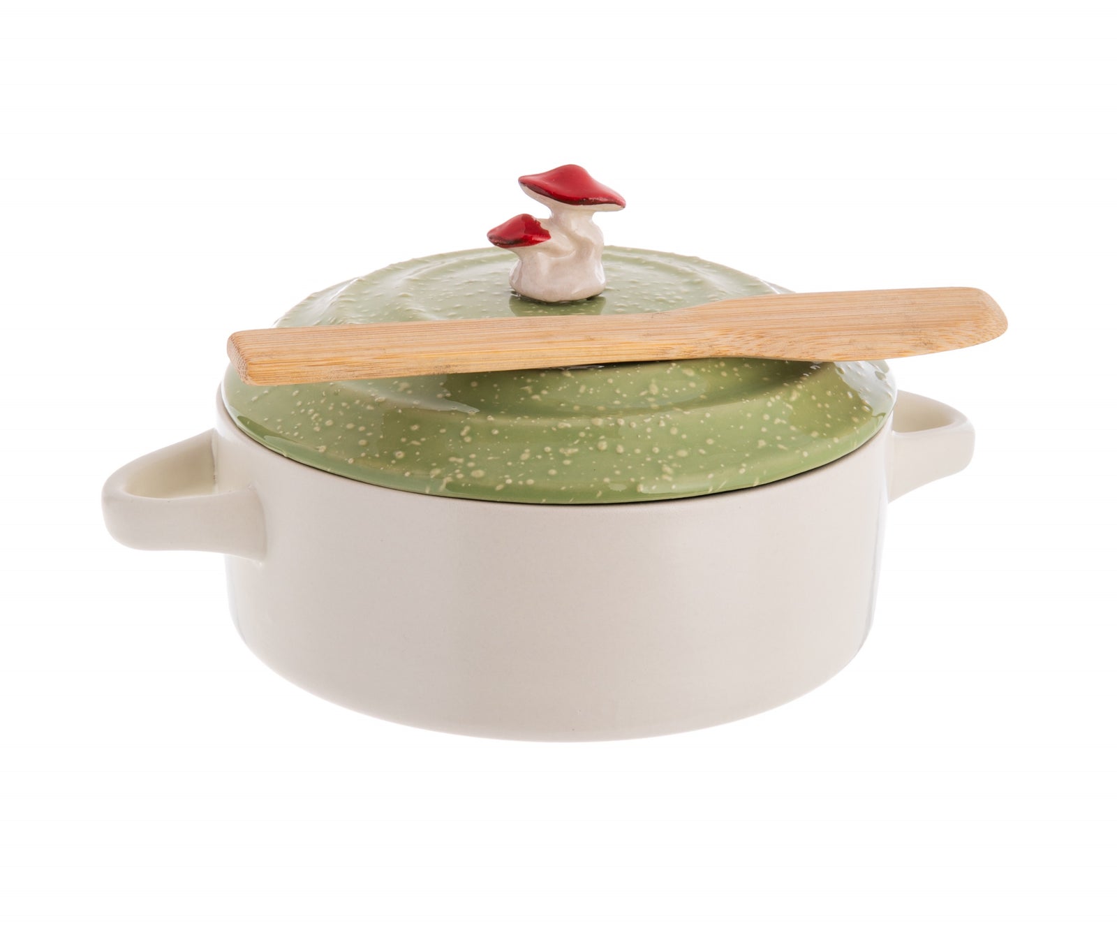 A white ceramic brie baking dish with a green lid adorned with a whimsical red field mushroom, accompanied by a bamboo spreader.