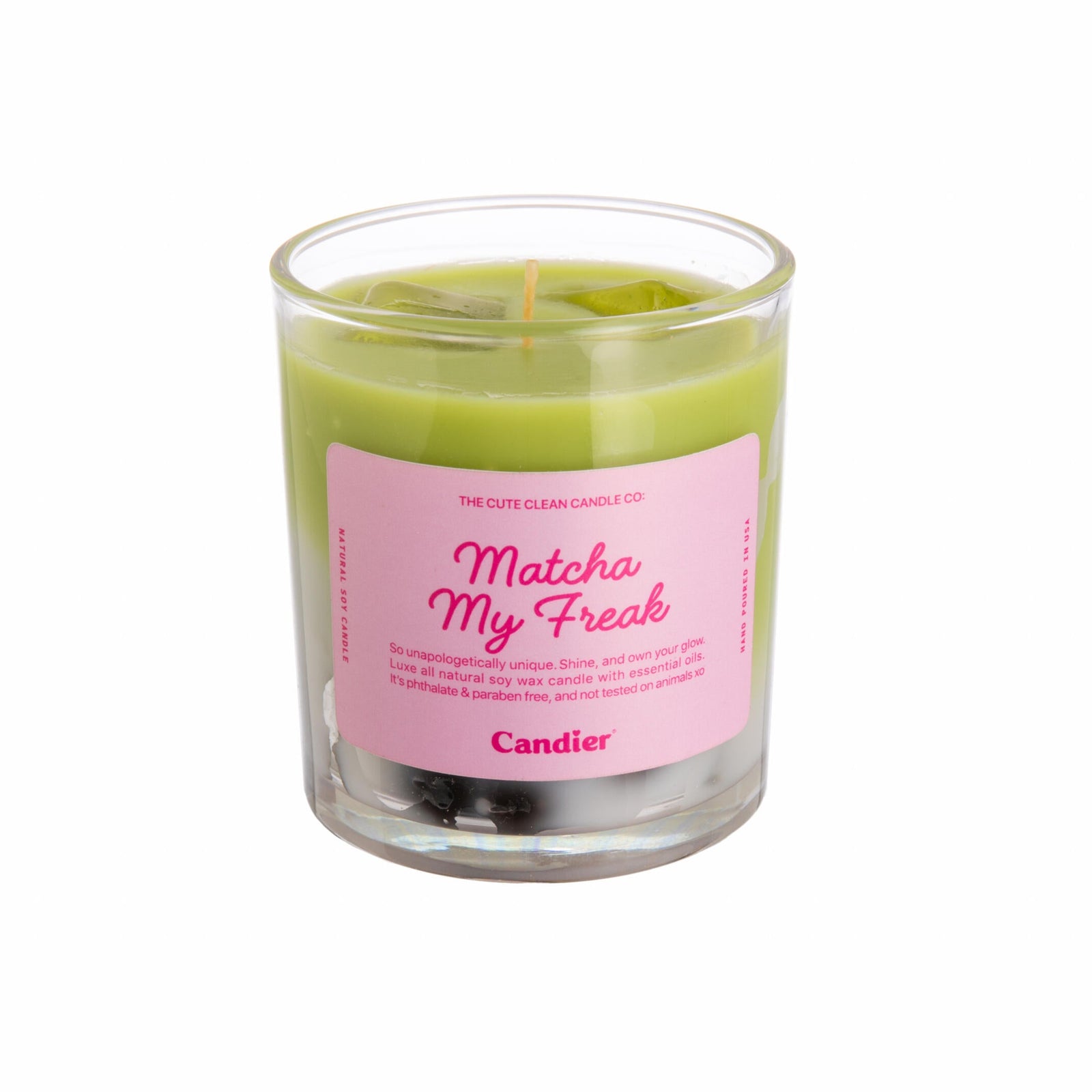 Green candle in a glass jar with a pink label on a white background