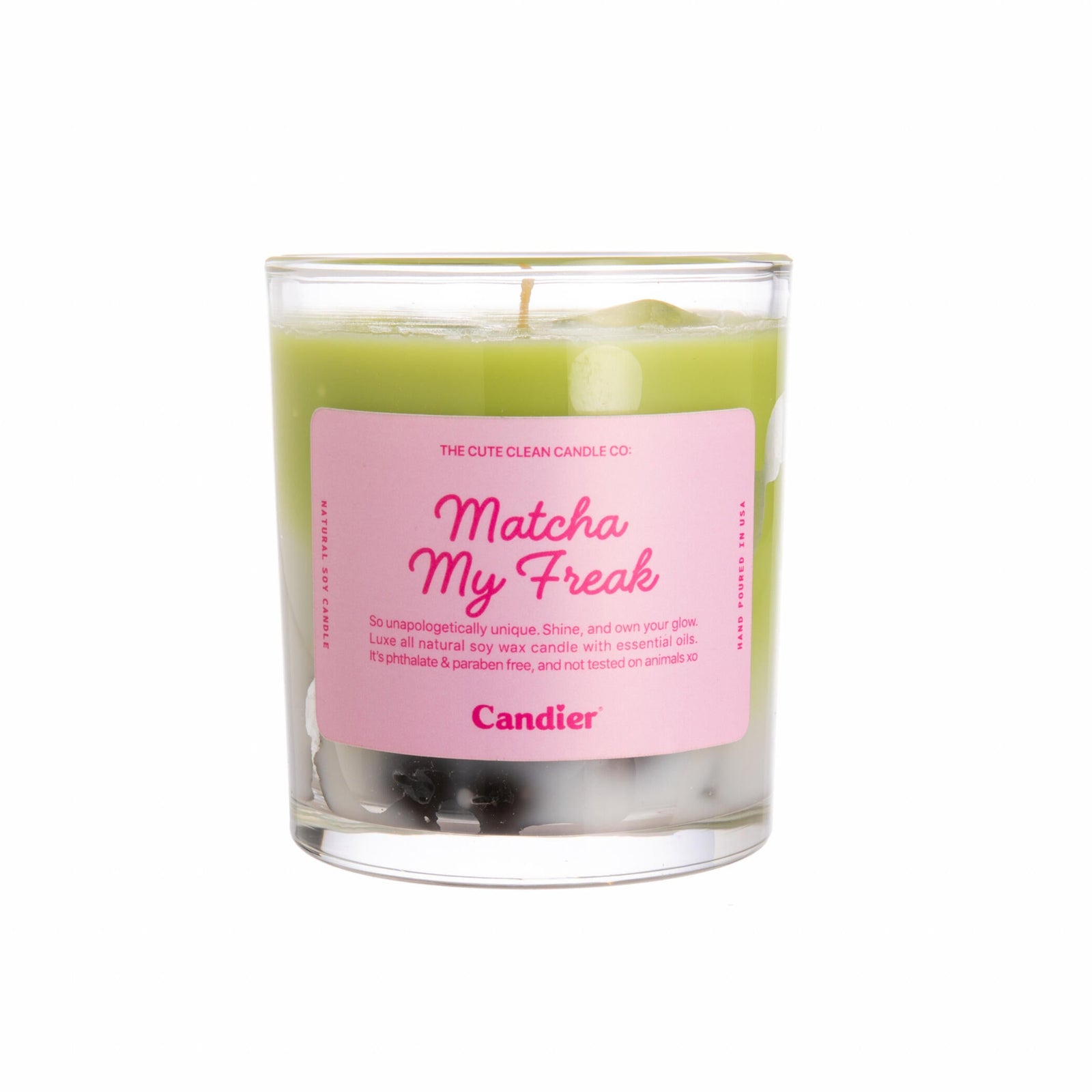 Green candle in a glass jar with a pink label on a white background