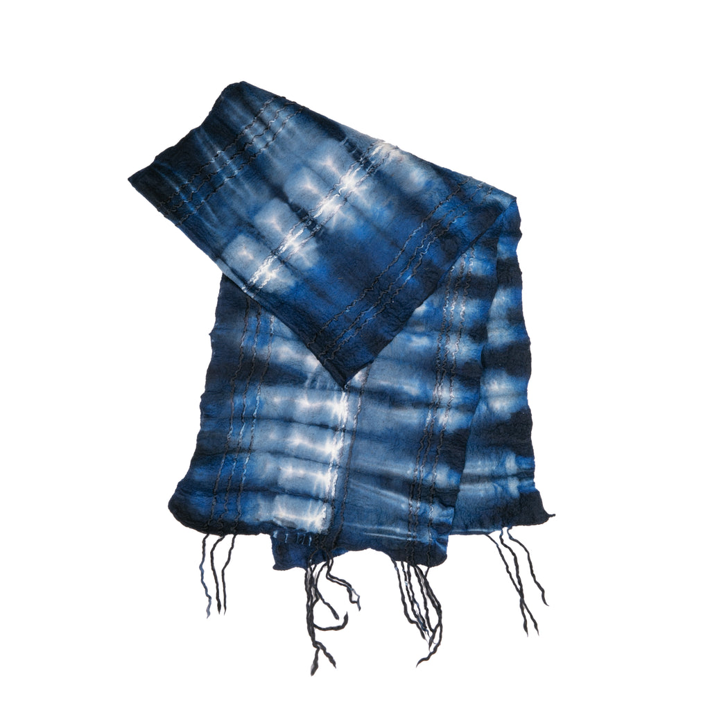 Wrap yourself in cozy vibes with this indigo wool scarf. Warm and chic, this scarf was hand-felted by artisans in South Africa and features a color and design inspired by the landscapes of that country. Material: 100% wool Made by South African artisans