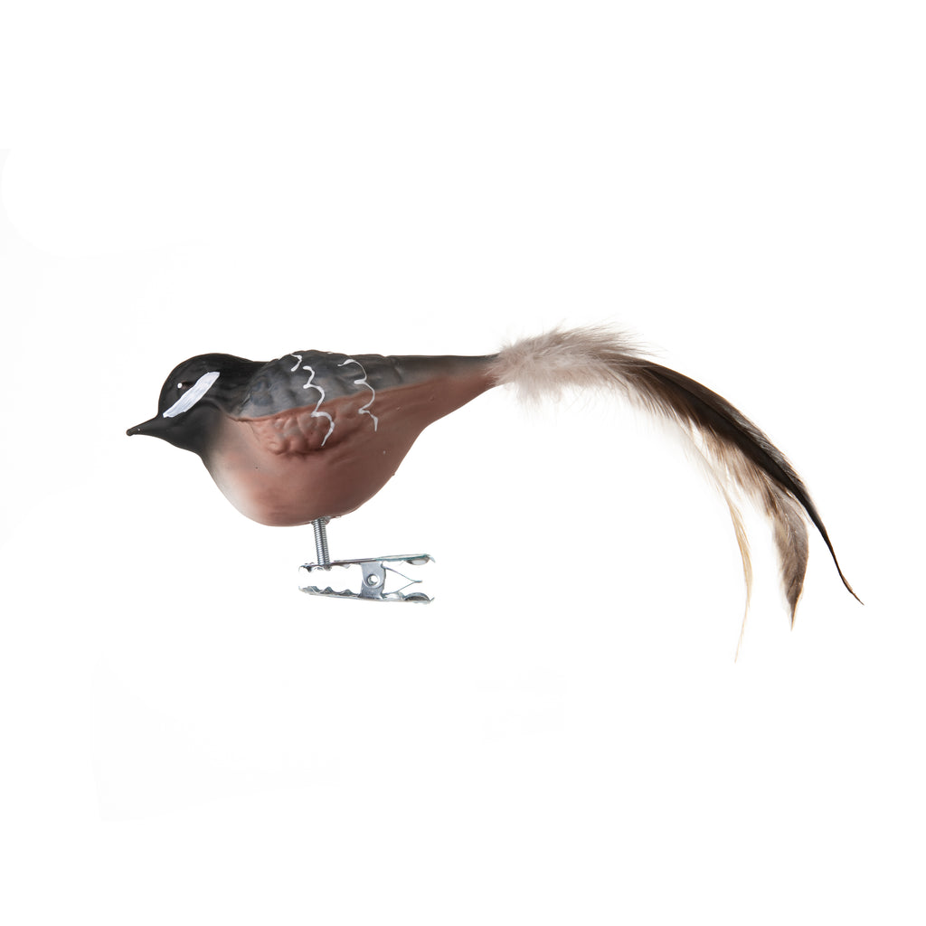 This coal tit bird is made from hand-blown glass in a family-owned studio. Its tail is made with real feathers and has a hand-painted finish.