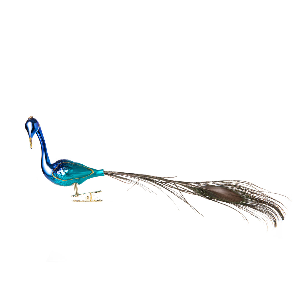 This small turquoise peacock is made from hand-blown glass in a family-owned studio. Its tail is made with real feathers and has a hand-painted finish.