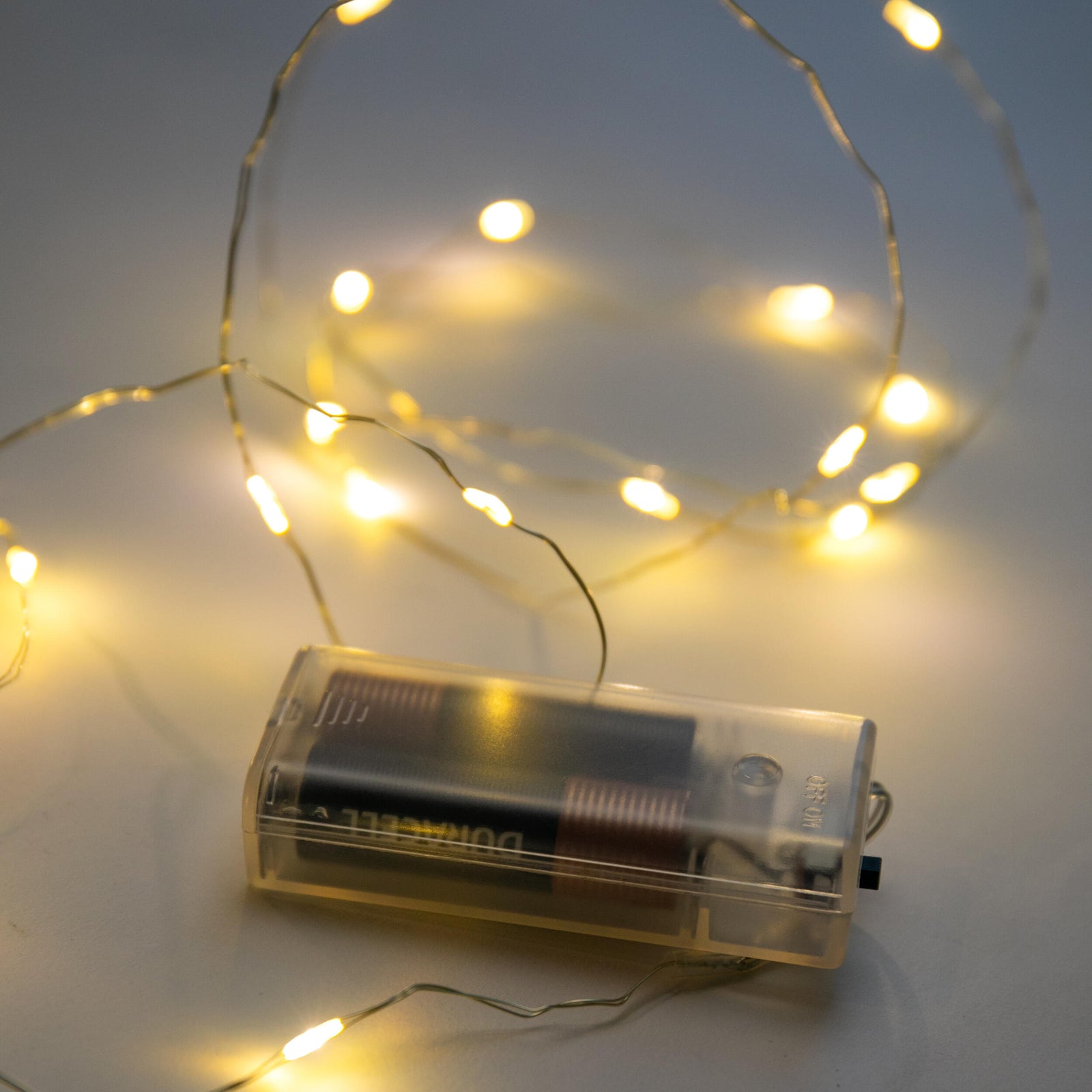 Sets of miniature LED string lights on lantern shaped backing cards, on a white background.