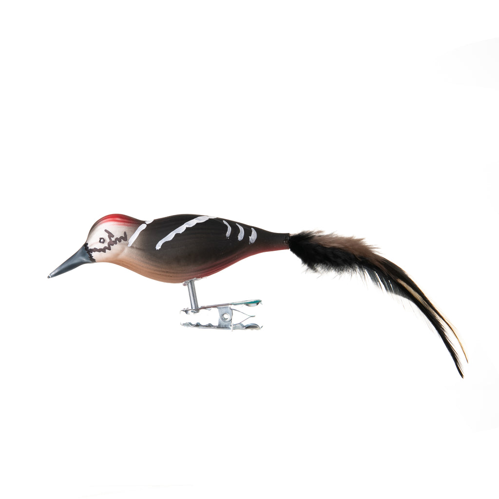 This great spotted woodpecker is made from hand-blown glass in a family-owned studio. Its tail is made with real feathers and has a hand-painted finish.