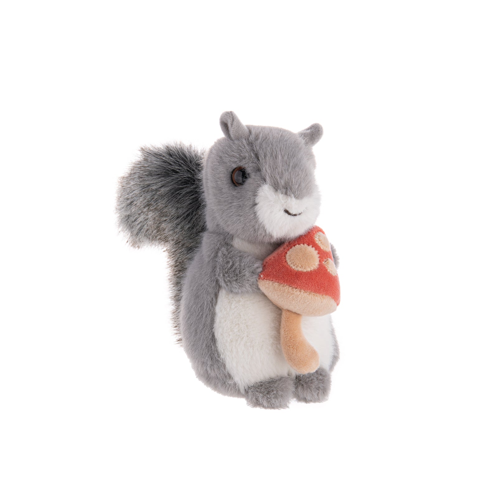 This plush Squirrel with Mushroom is so cute, it makes us want to go harvesting mushrooms immediately. With grey fur, a salt and pepper tail, and a whimsical red mushroom, this plush buddy is happy to show off his new find.  Dimensions: 4.5" x 3.5" x 5.75" Material: Polyester, Plastic Pellets Recommended age: 2+