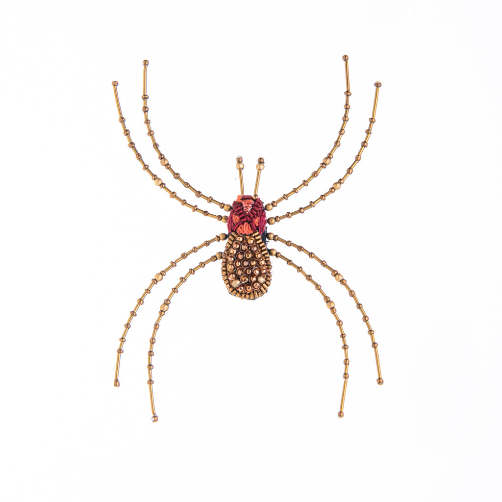 This amazing arachnid is more delight than fright! Hand crafted with extraordinary attention to detail, using sequins, beads, metal, embroidery and felt. Add to your favorite little black dress or jacket for a colorful, elegant touch of drama. Dimensions: 4.25" L x 3.5" W Material: Cotton, Felt, Metal, Sequins & Beads.