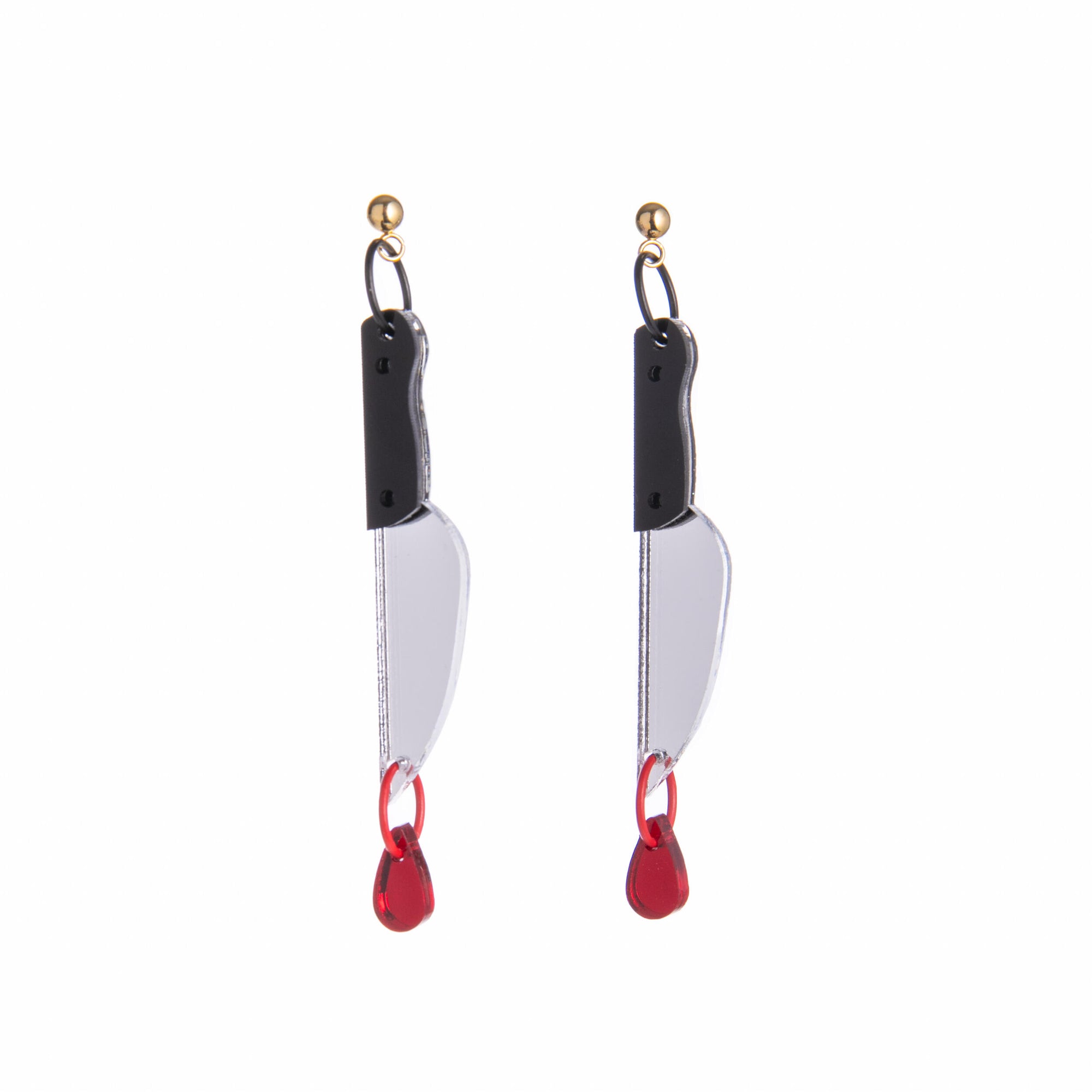 Pair of knife-shaped earrings with red accents on a white background