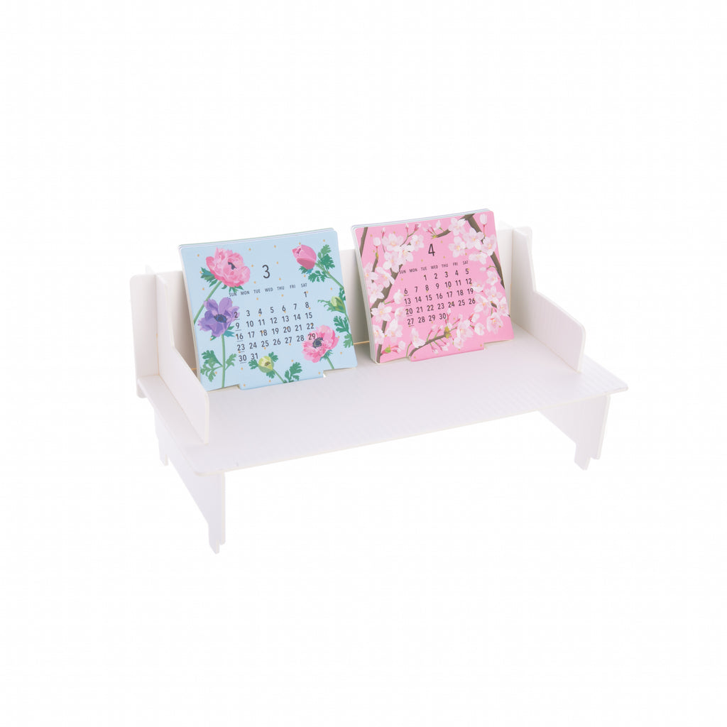 This Sofa Calendar for 2025 is the cutest little piece of furniture for your desktop or table. With 12 monthly cards, flip each month out when done, as if they were cushions on a sofa. Each month card has a flower for each month making it a colorful calendar. Desktop calendar Dimensions in package: Approx. 8" W x 4" L