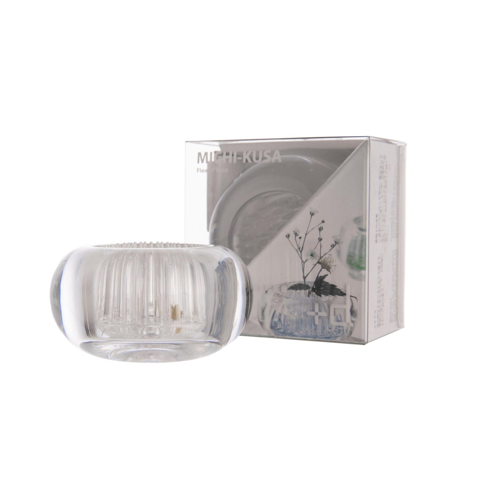 Clear glass Ikebana flower arranging holder with packaging on a white background