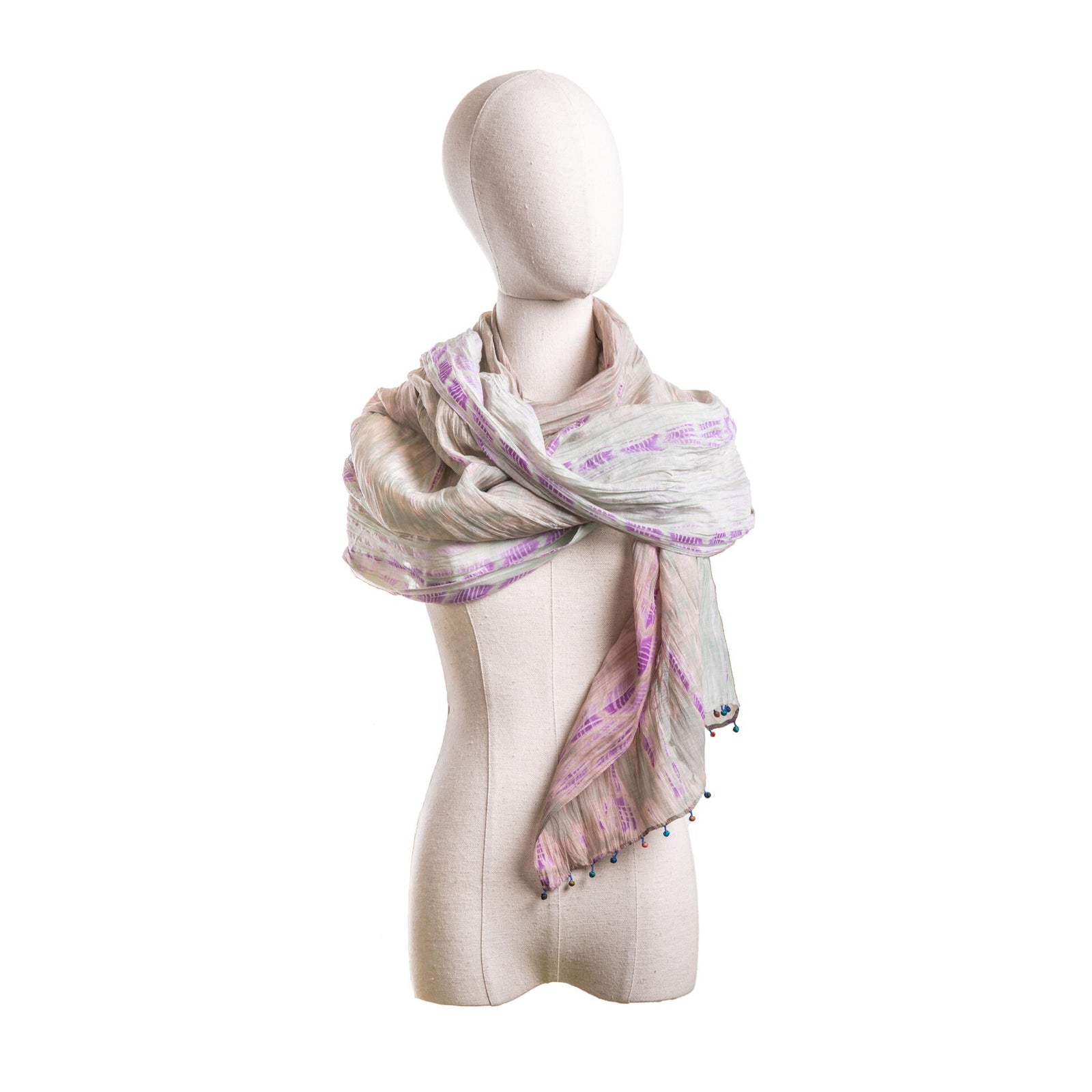 Mannequin wearing a patterned scarf on a white background
