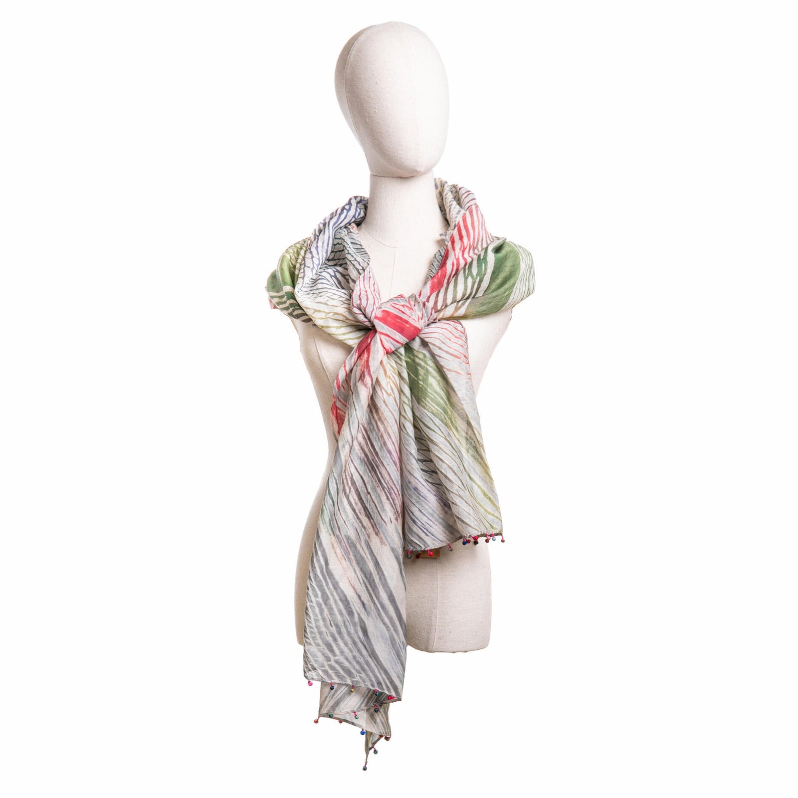 Mannequin wearing a patterned scarf on a white background