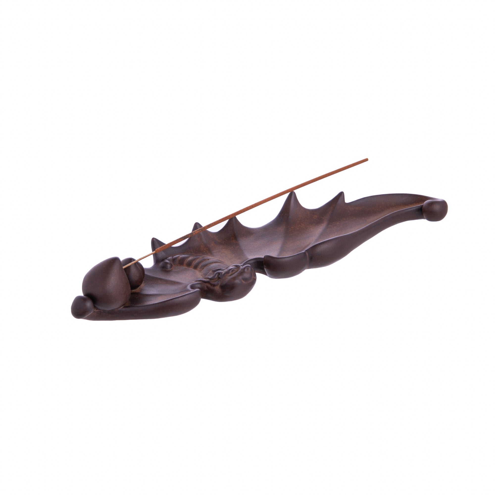 In some cultures, bats symbolize good fortune and longevity. Honor these nocturnal critters with this clay bat incense holder. The incense holder placement lives at the end of its wing and would look equally cute on either a shelf or countertop. Dimensions: 10.5" L x 3" W (at widest point) Material: Clay.