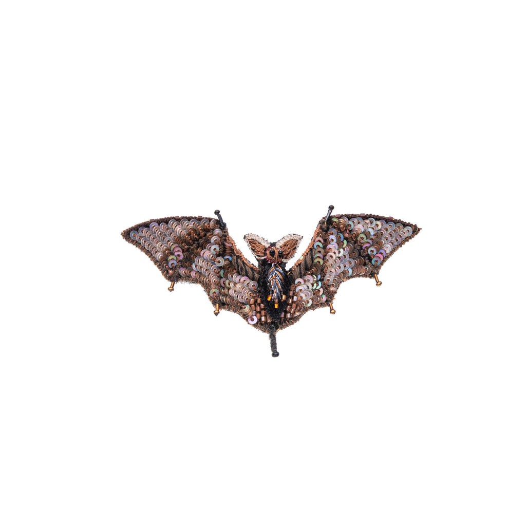 This beautifully detailed, hand-made bat brooch features intricate beading and embroidery on a base of cotton and felt. Add this pin to your outfit for a dose of spooky, and to show your love for this nocturnal cutie. Hand-made Materials: Cotton, felt, metal, beads Dimensions: Approx. 3" x 1.5"