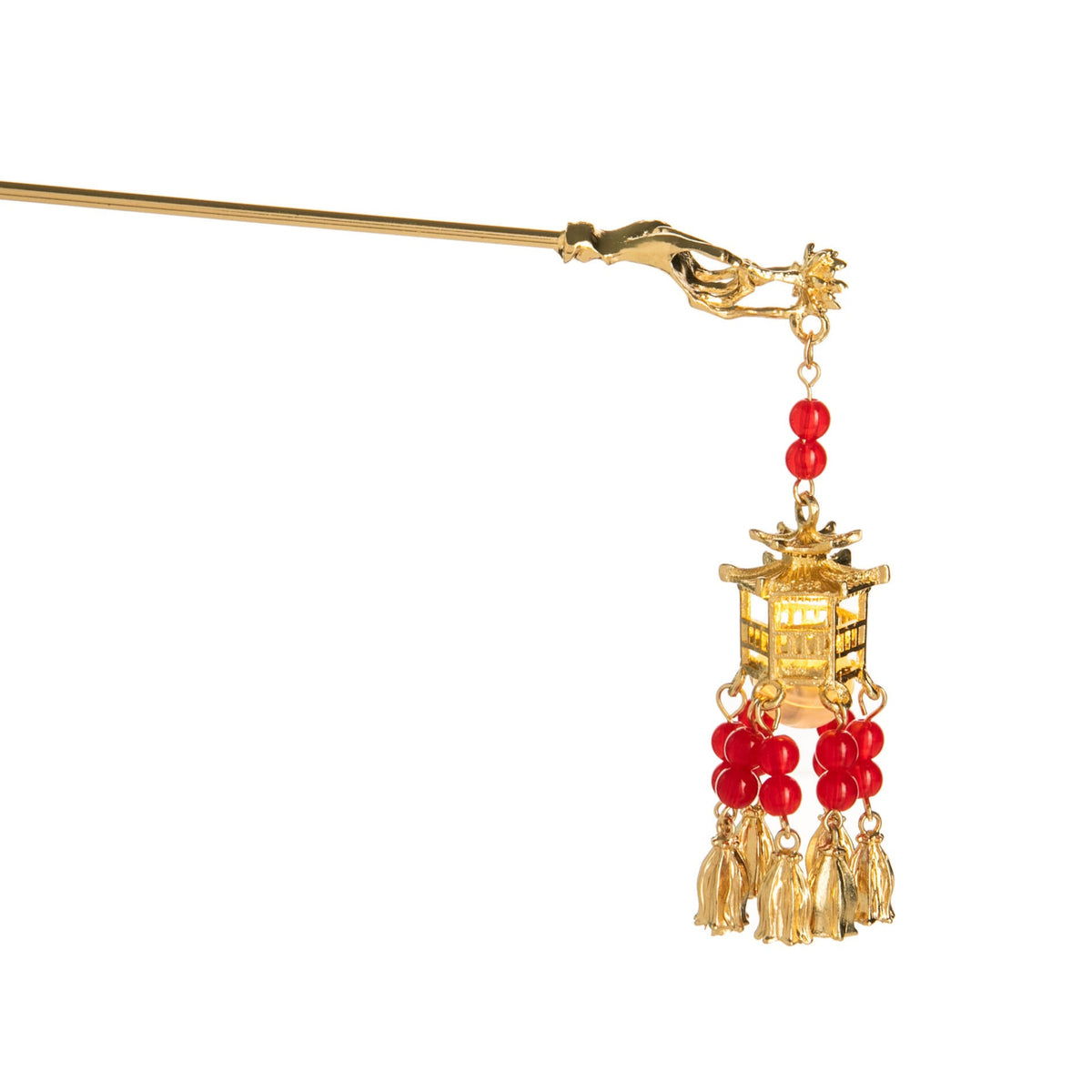 Gold hairpin with red beads and tassels on a white background