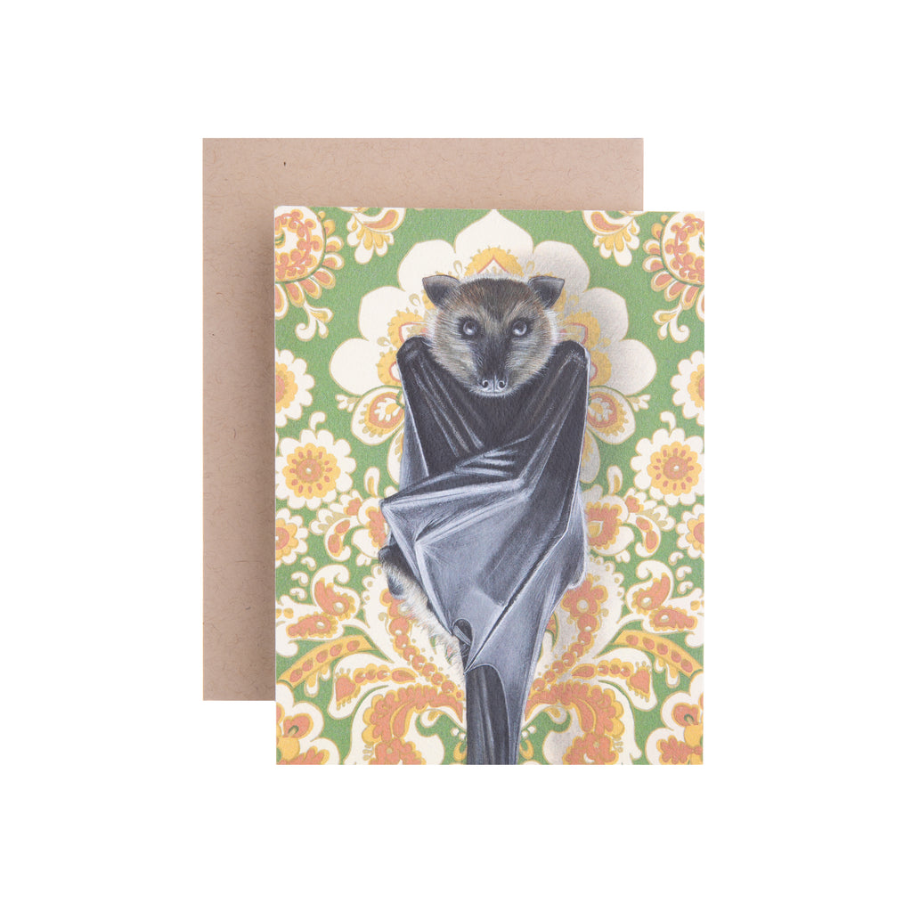 We are going absolutely batty for this fox bat notecard! The bat is featured hanging upside down and looking very cute in front of a green floral wallpaper. The card is blank inside, and would be perfect for any birthday or anniversary. Dimensions: 4.25" x 5.5" Printed on recycled paper Blank inside Brown envelope