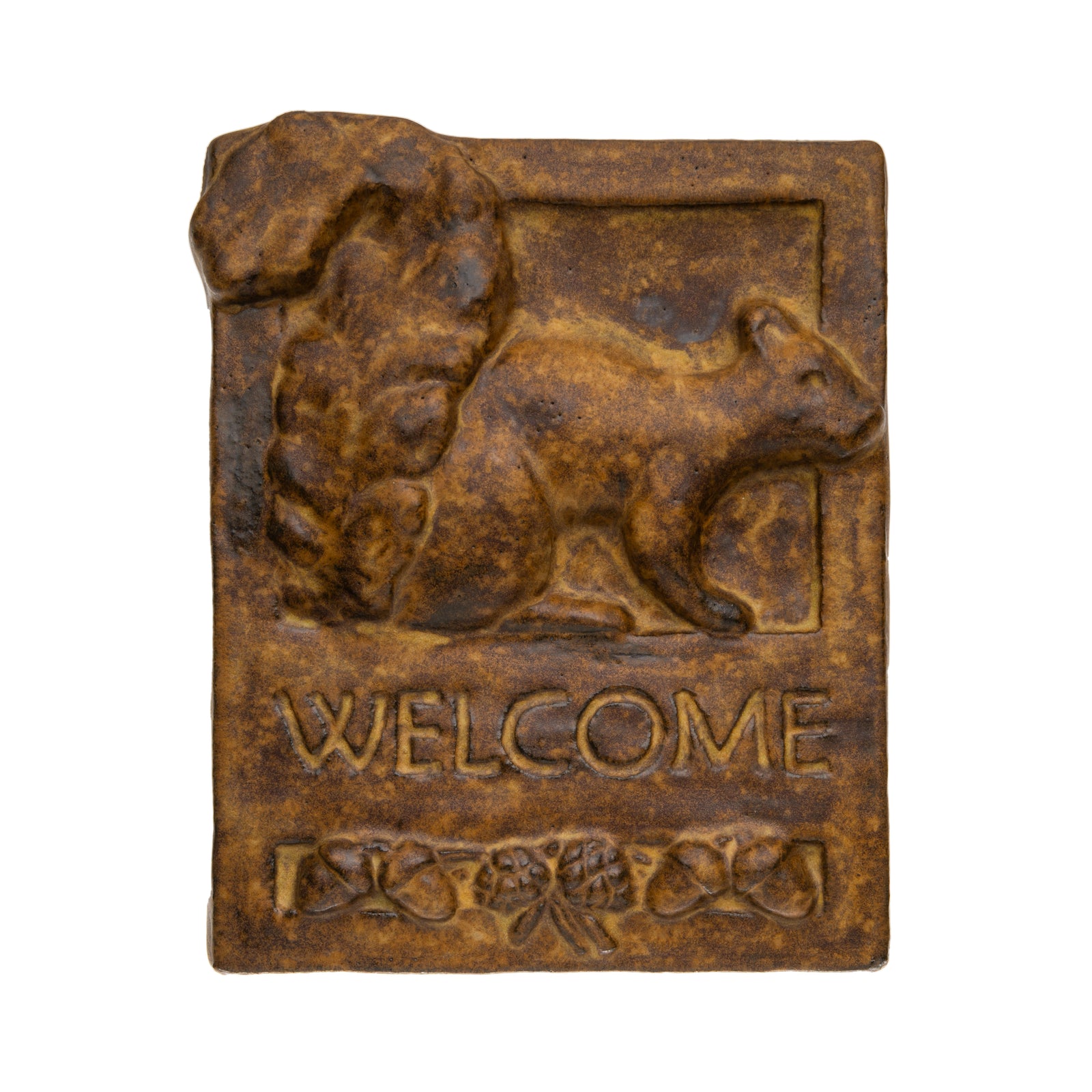 Inspired by the simplicity and style of the Craftsman movement, this handmade ceramic 'welcome' tile features a squirrel with a stack of acorns. It is hand fired and glazed with a vintage-style tan glaze, and has a cord attached to the back for easy hanging. Dimensions: 8" x 12" x 2" By artist Janet Ontko. Made in USA.