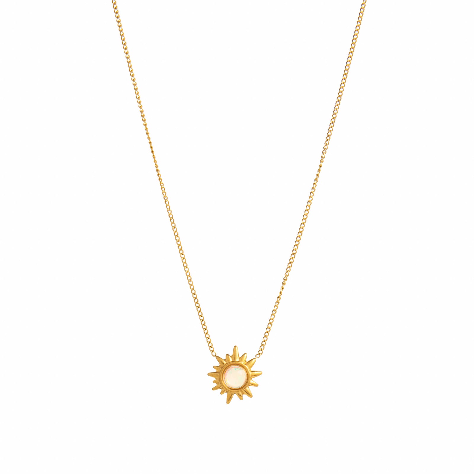 Gold sun-shaped pendant necklace on a white background