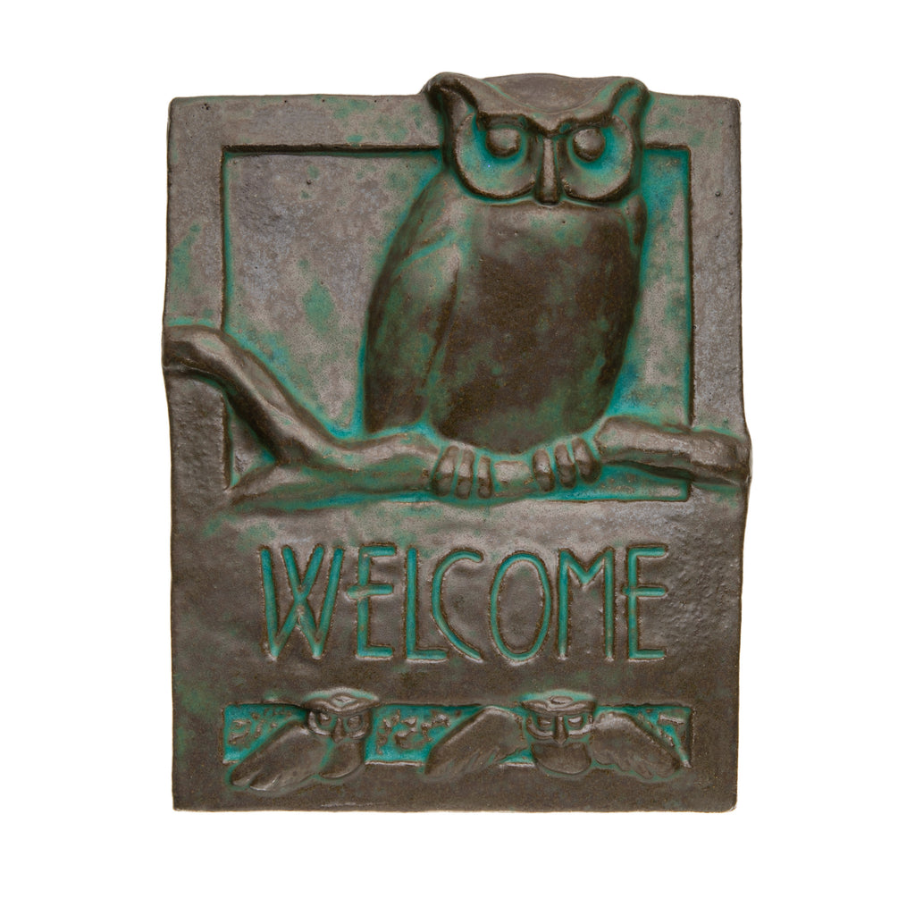 Inspired by the simplicity and style of the Craftsman movement, this handmade ceramic 'welcome' tile features a wise old owl sitting on a branch. It is hand fired and glazed with a vintage-style 'evergreen' glaze, and has a cord attached to the back for easy hanging.  Dimensions: 8" x 12" x 2". Made in California.
