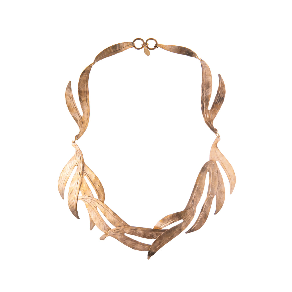 Look and feel like a goddess in this Maharani necklace that will instantly add a gold statement to any outfit. This necklace is adorned with leaf-like pieces evoking nature. Delicate detail shines in light but very durable hand-hammered brass. Material: Hand-hammered brass  Dimensions: 18" long Nickel and lead-free