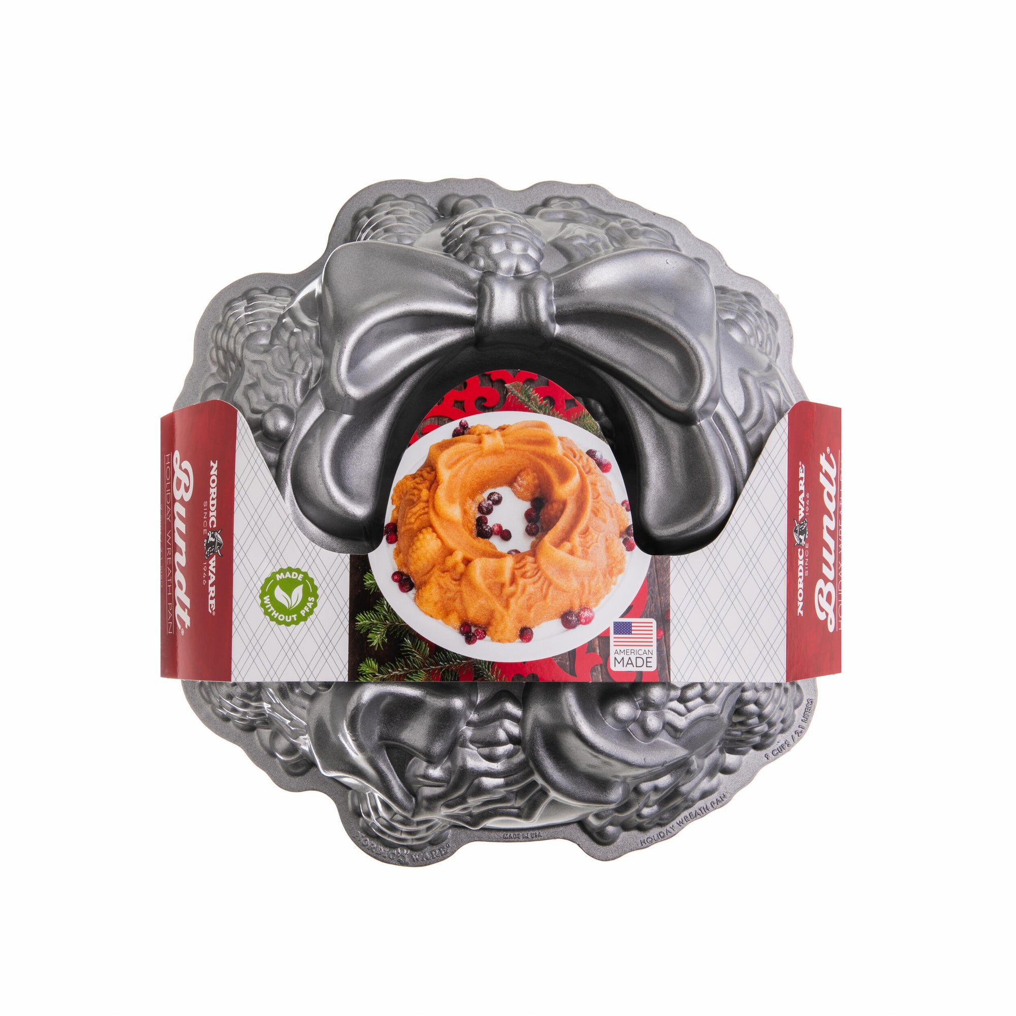 Metal Bundt cake pan with decorative lid on a white background