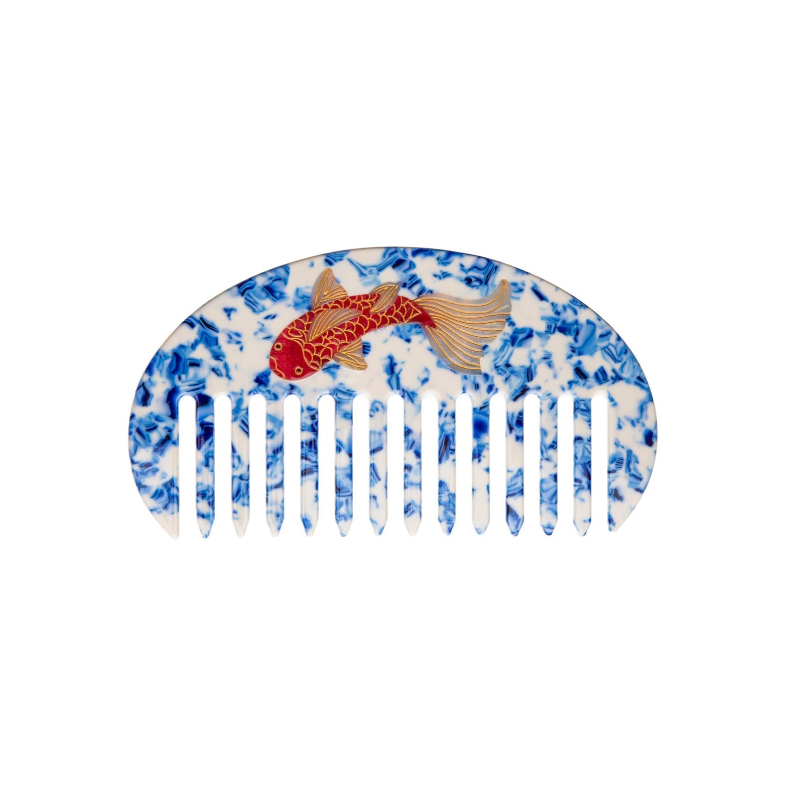 Decorative comb with blue and white pattern and koi fish motif on a white background