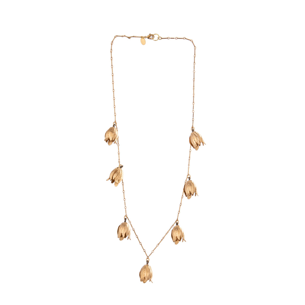 This gold Tulip Blossoms Necklace is a stunning chain with tulip detail, perfect for layering or wearing alone. Finely detailed brass tulip blossoms shimmy and sway along the brass bar chain.   Closure is a lobster clasp.  Material: Brass  Dimensions: 26" long Nickel and lead-free