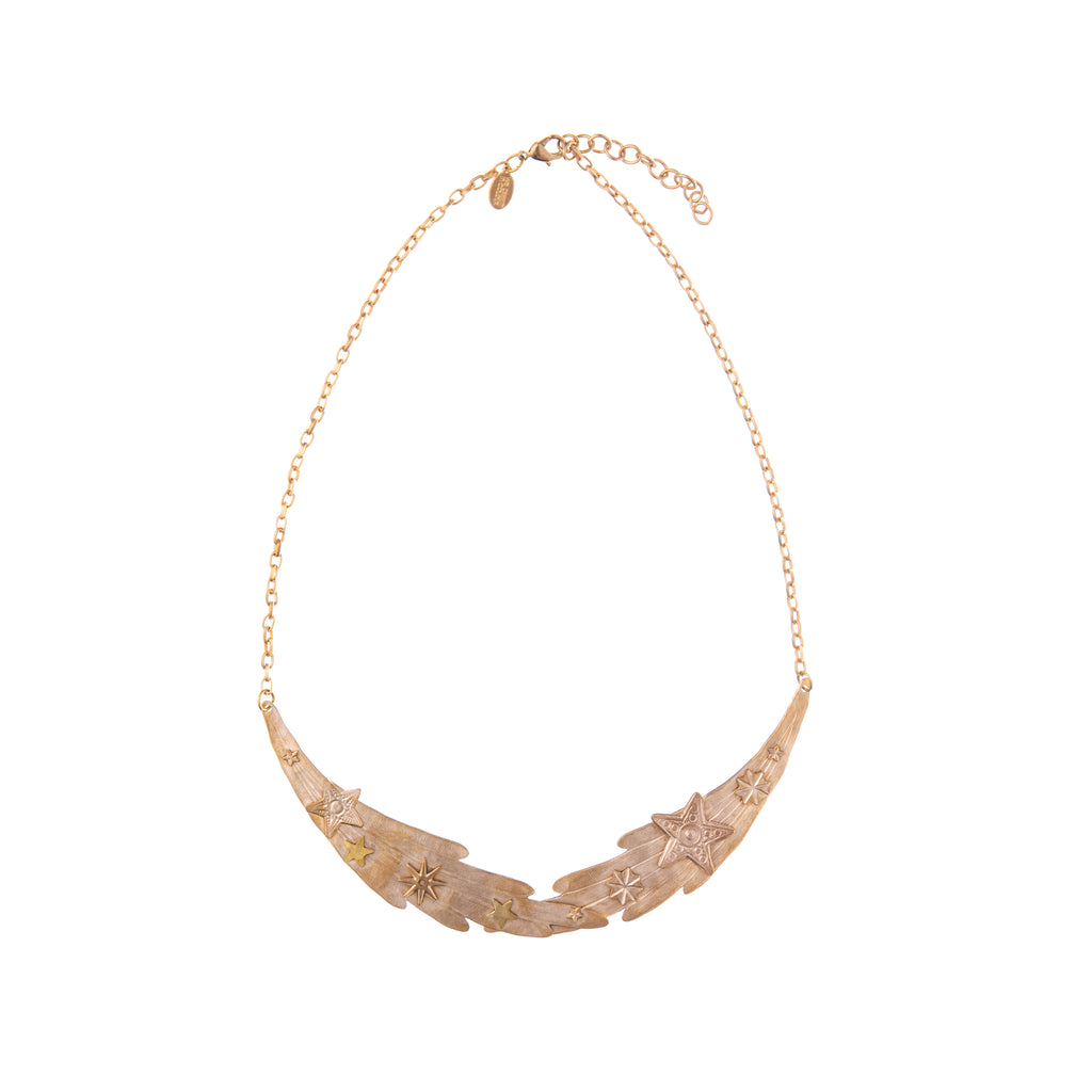 This Starry Comet gold-plated necklace is a gorgeous flash of glamour if you are looking to add more celestial objects to your jewelry collection. Adorned with star detail along the comet, this necklace is a great statement piece. Material: Gold-plated brass  Dimensions: 7" long Nickle and lead-free