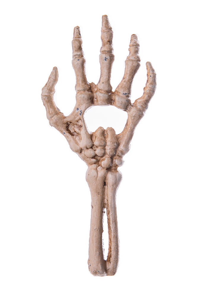 Tickle your funny bones with this Skeleton Hand Bottle Opener. Handmade with cast iron, get the Halloween party started by using this poor old soul's hand to open your bottles of spirits. This bottle opener would look great as decor. Handmade bottle opener Material: Cast Iron Dimensions: 7" L x 3" W