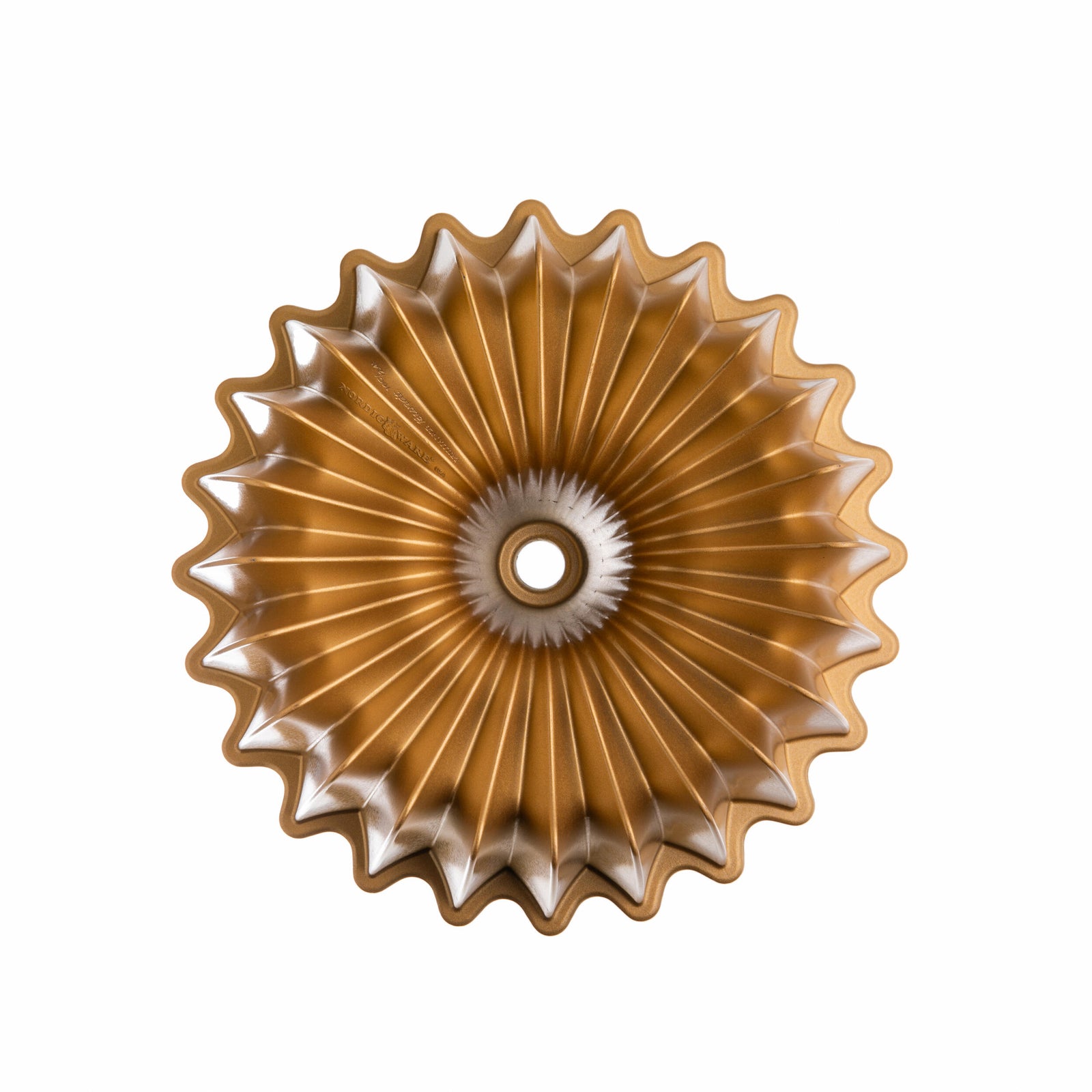 Sunburst shaped gold colored bundt baking pan on a white background.