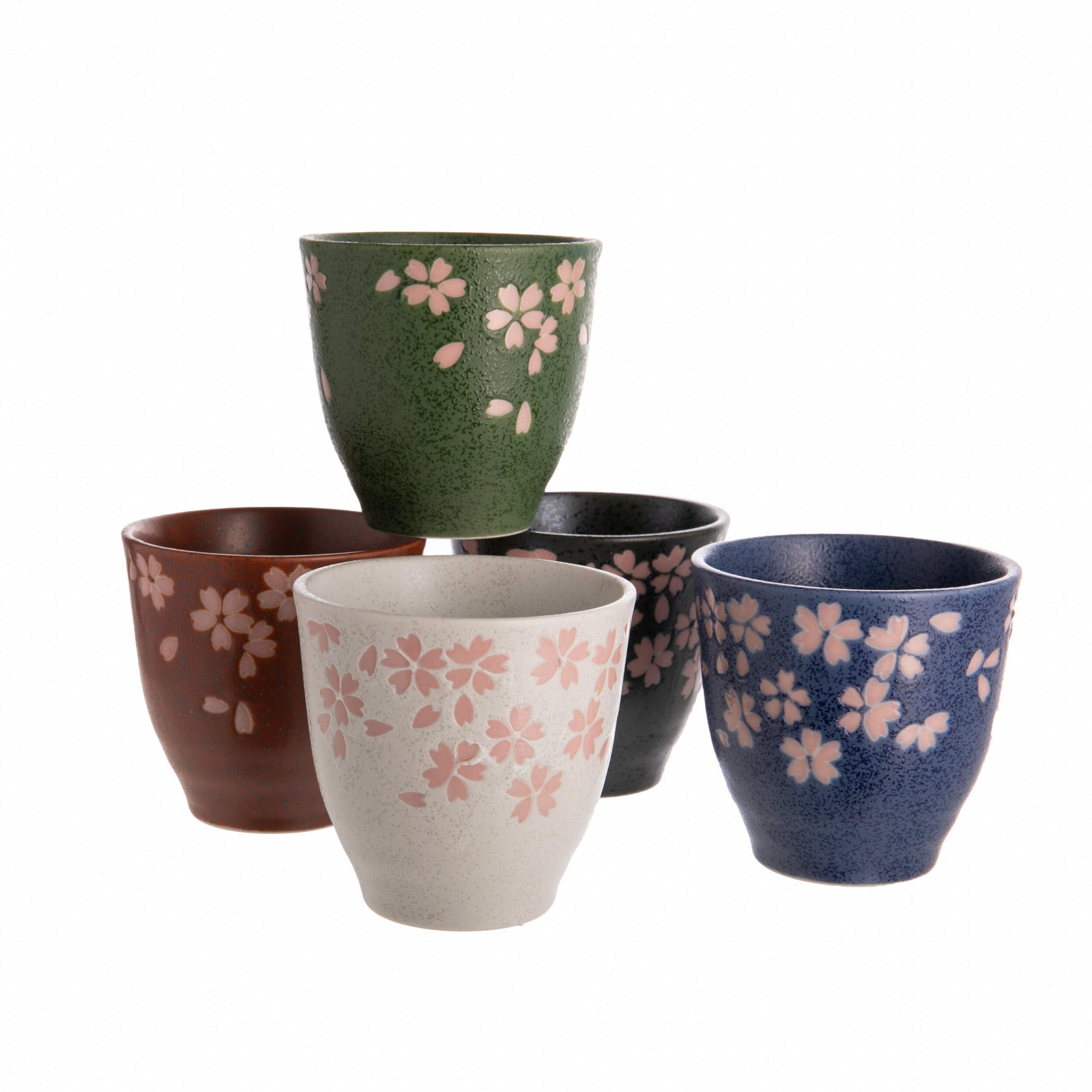 Set of five ceramic cups with floral patterns in various colors on a white background