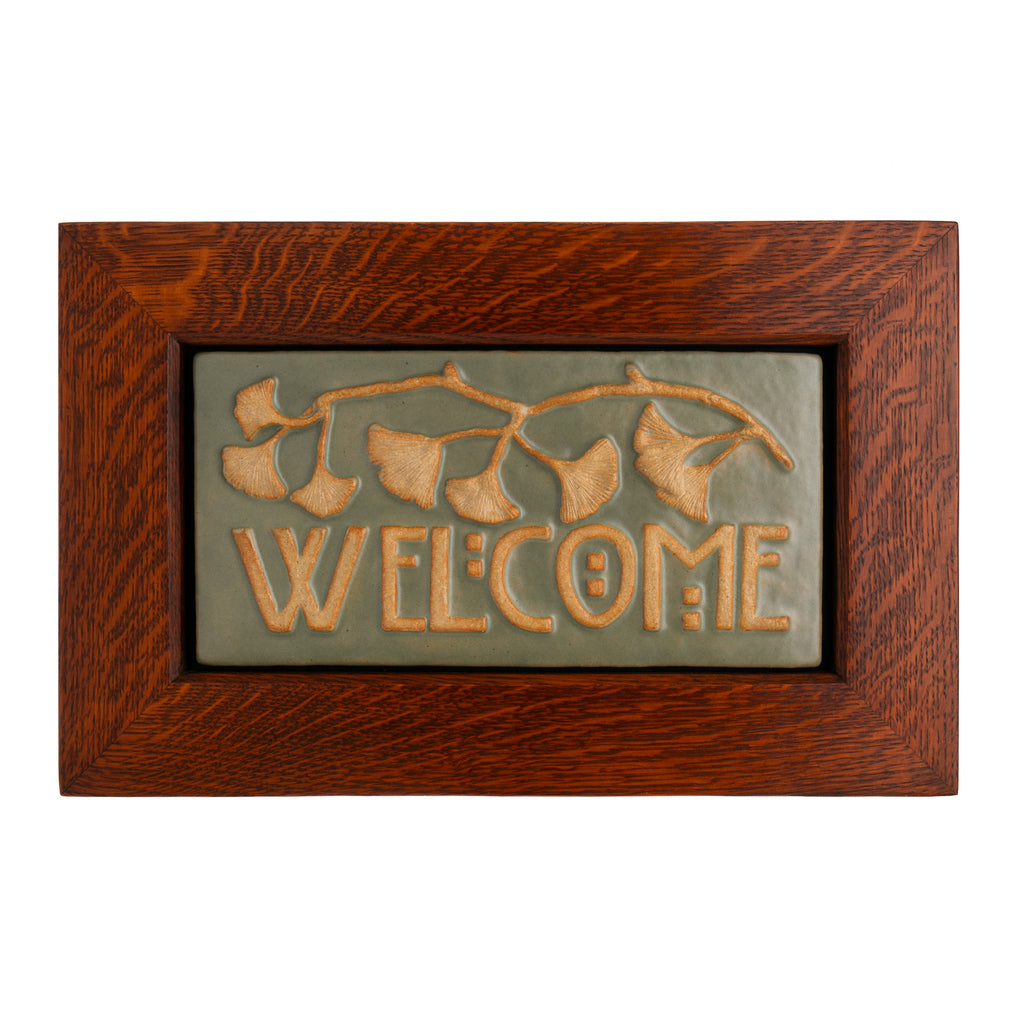 Welcome people to your home with this beautiful artisan craft ginkgo tile. Each tile is hand made in small batches in the USA, and is then carefully framed in beautiful white oak, creating an authentic, Craftsman style decor piece. Tile is 6 x 12". Framed is 11 x 15 1/2" Tile is handmade in small batches.