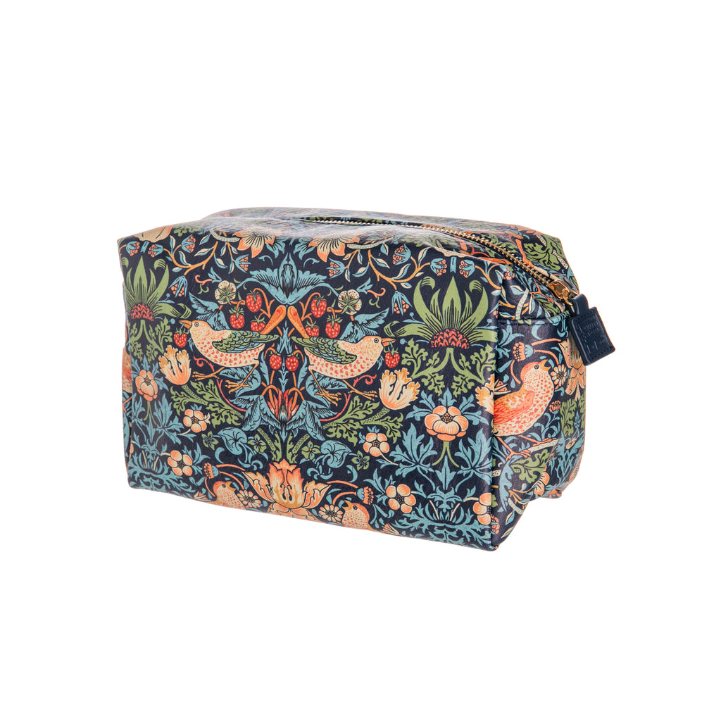 This spacious William Morris print wash bag features the iconic Strawberry Thief design in rich navy and is roomy enough to store your toiletries and beauty essentials in style. Generously sized wash bag measures approximately: 9.5" x 5.5" x 6". Cruelty-free and vegan friendly. Designed in England. 