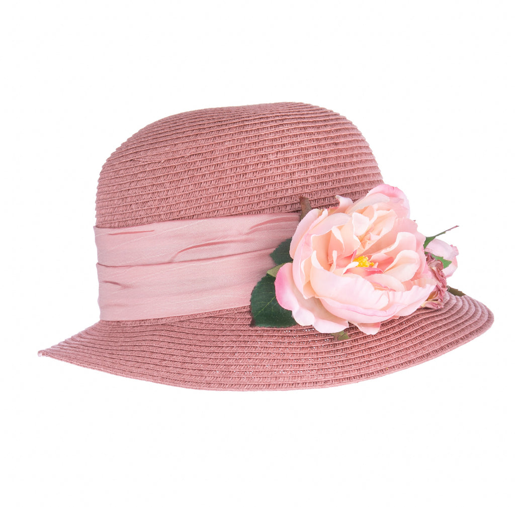 Stylish sun protection can be yours in this beautiful dusty-rose colored cloche hat. It is trimmed with a matching satin hatband and finished with a bouquet of pink flowers. Made from a durable, breathable and packable paper straw, this is a perfect hat for any summer event. Crown size approx 24". Made in the USA.