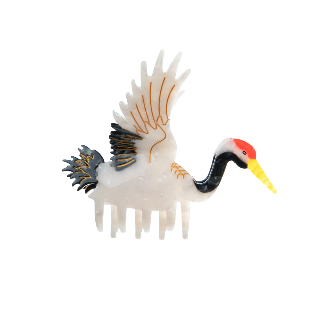 This fabulous hair clip features a majestic crane in full flight. This unique hair clip is hand finished and carefully crafted from cellulose acetate; an eco-friendly, biodegradable material made from recycled wood pulp. Dimensions: 4" x 3.5" Double-sided design. Eco-friendly cellulose acetate.