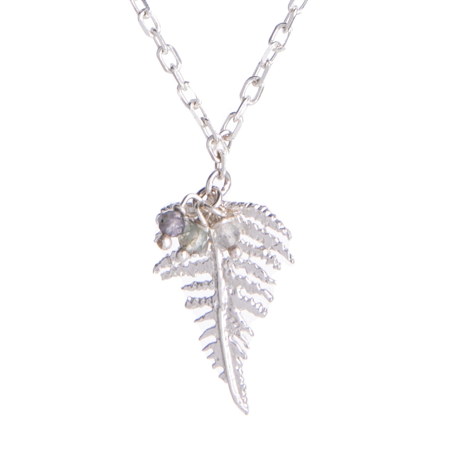 A silver necklace with a small fern leaf-shaped pendant, featuring labradorite, iolite, and green onyx beads on a chain.