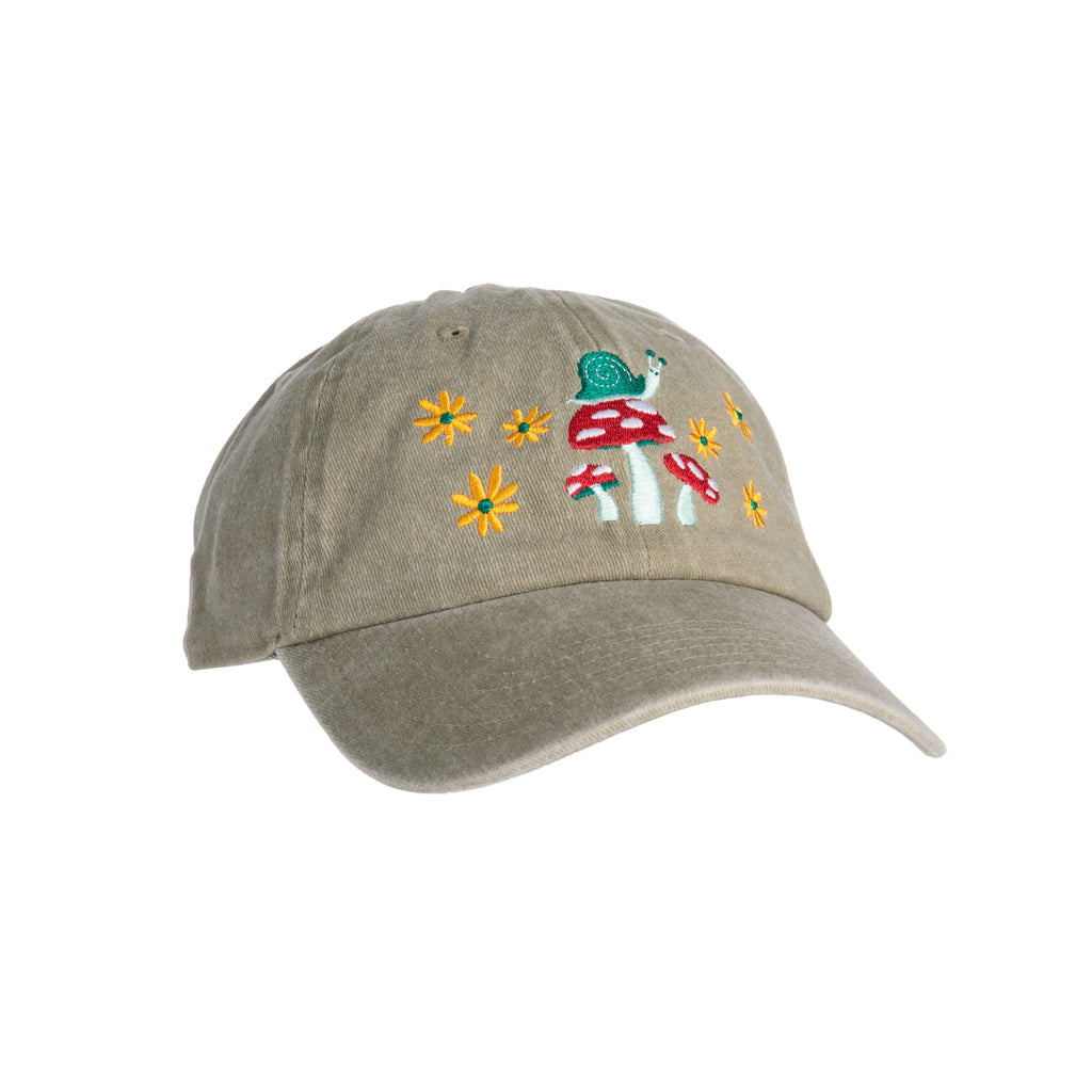 This soft, washed khaki-colored baseball cap features an embroidered snail on some mushrooms with flower details on the front, this cap is sure to charm others with its cute botanical friends. The cap features an adjustable metal buckle to ensure the perfect fit. Materials: Cotton, Metal. One size. Adjustable buckle.