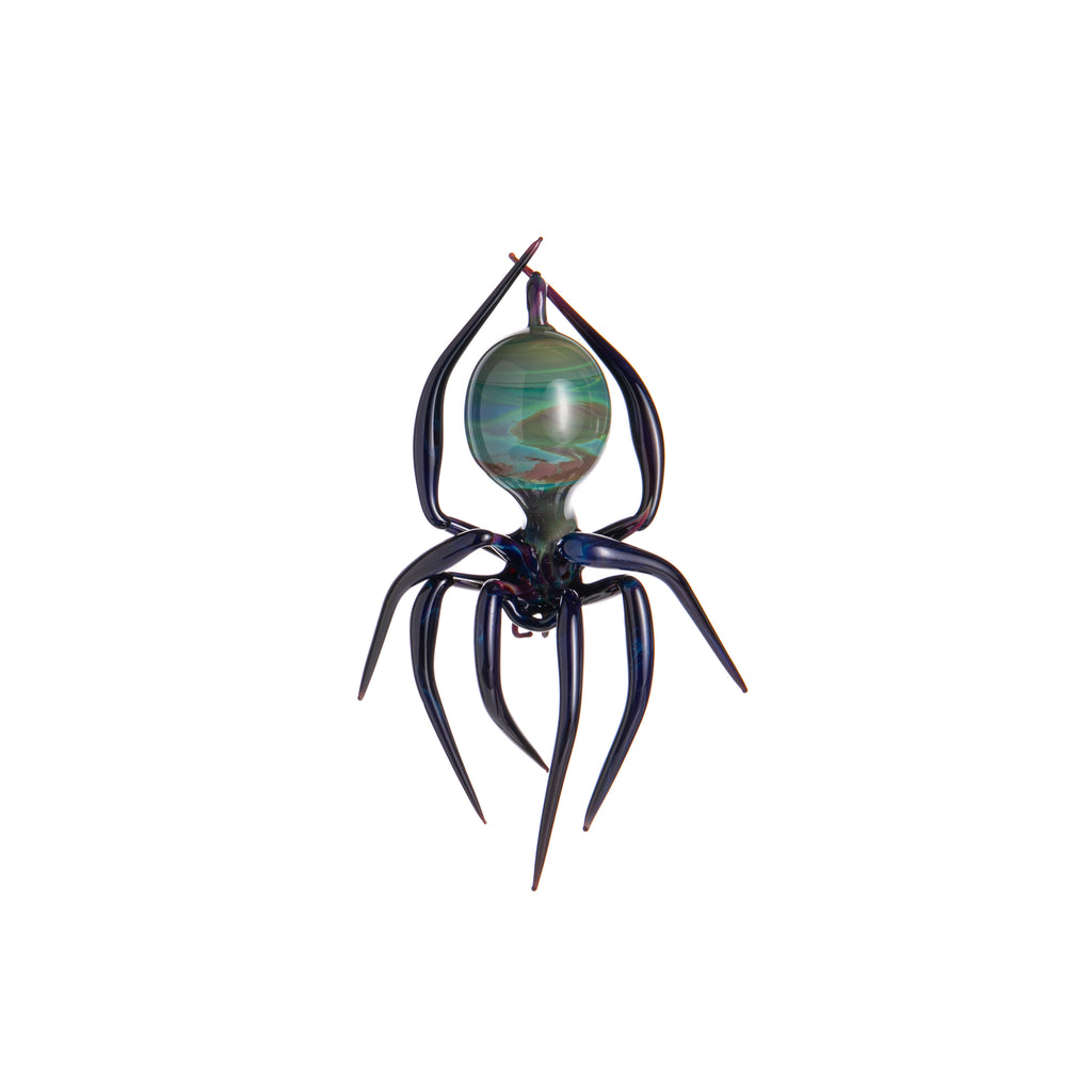 Perfect for your Halloween or Christmas tree, or just hung up all year, this handmade and unique glass-blown spider is absolutely stunning. With its long legs and multicolor glass body, we would be grossed out if it wasn't so beautiful! Includes glass loop for hanging.  Dimensions: 5" x 3" Handmade glass-blown ornament